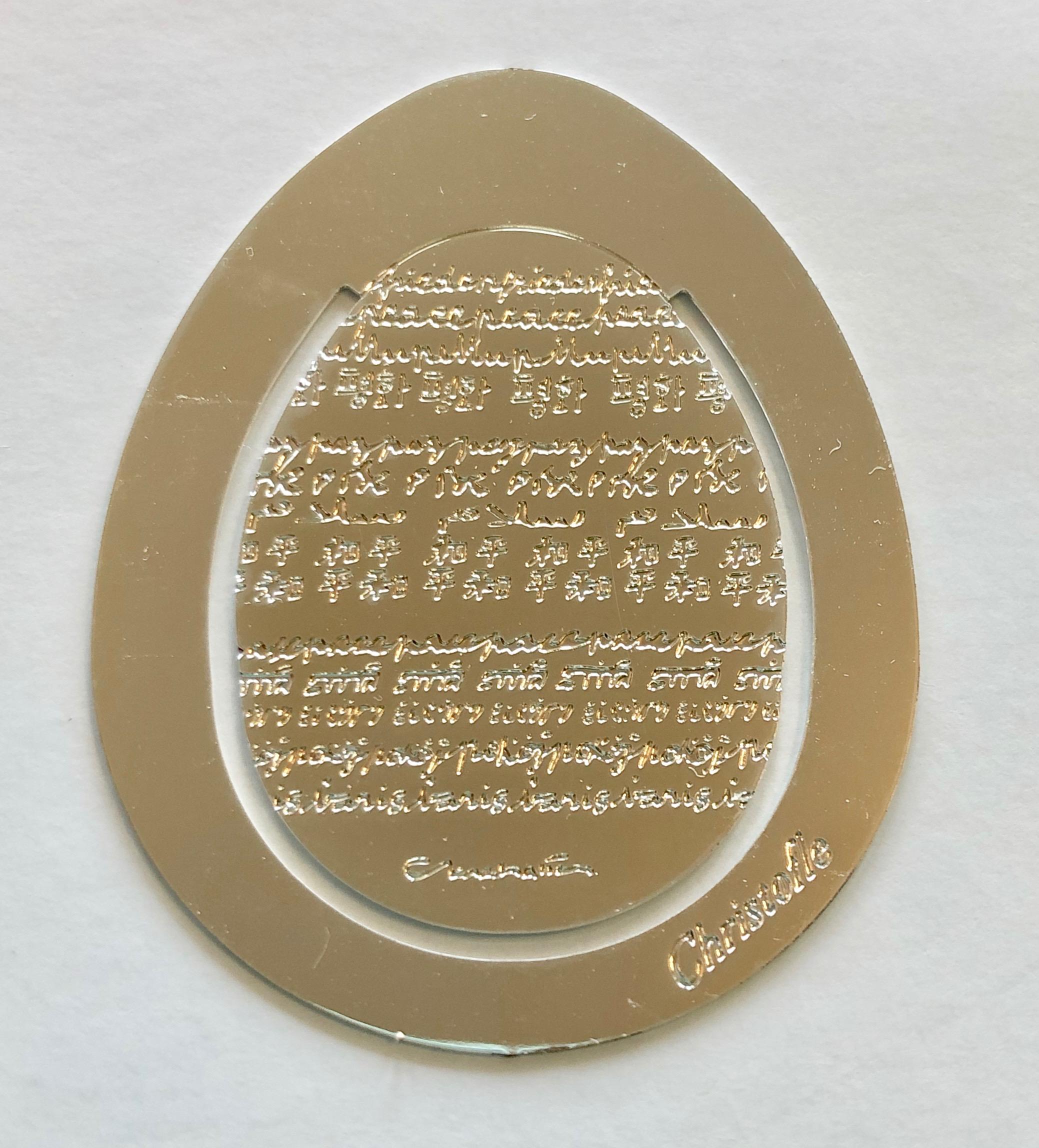 This is a wonderful French Christofle silver plated peace egg book page marker. The word peace is written on the egg in many different languages. It is new, never used and comes with it's case and envelope. (