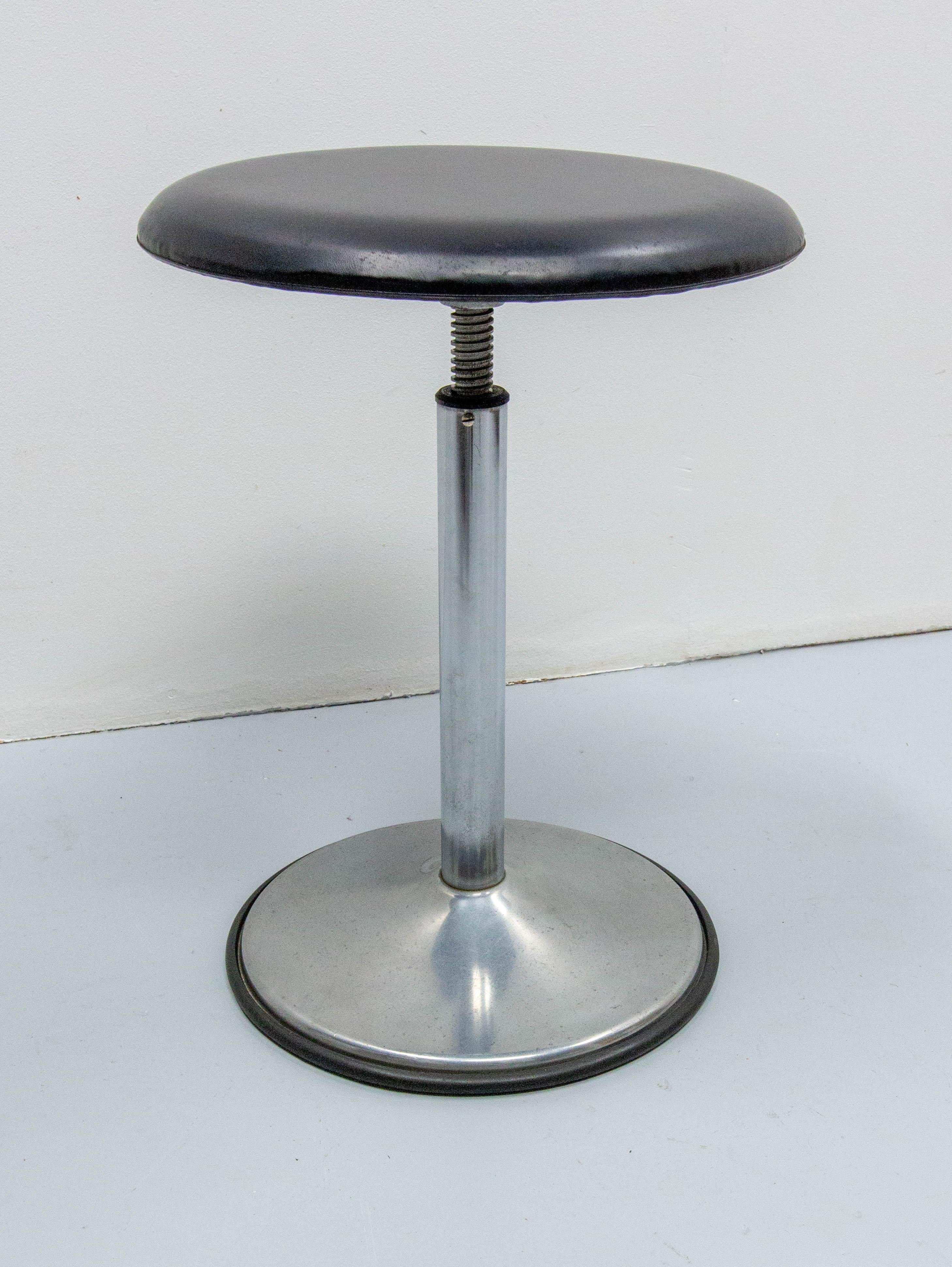 French  stool made circa 1950.

Thanks to a very careful previous owner the stool is in very good condition (especially the skai seat and the rubber)
The height can be adjusted with the central screw from  to 16.53 to 24.80 in. (42 to 63 cm)
Good
