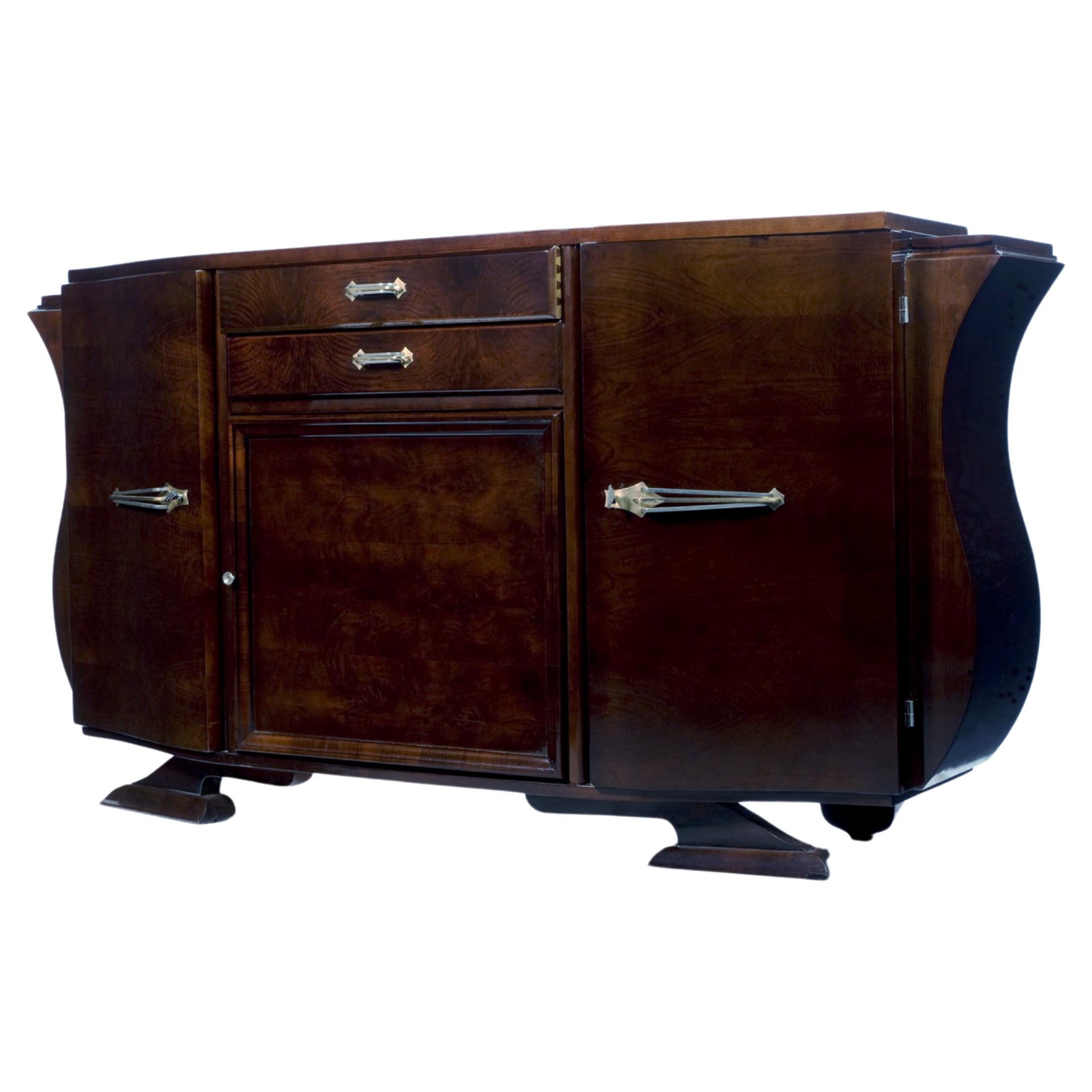 An exceptional and sophisticated sideboard, showcasing exquisite craftsmanship and sleek chromed hardware. This extraordinary piece, created during the first half of the 20th century, boasts two upper drawers and an internal partition with two