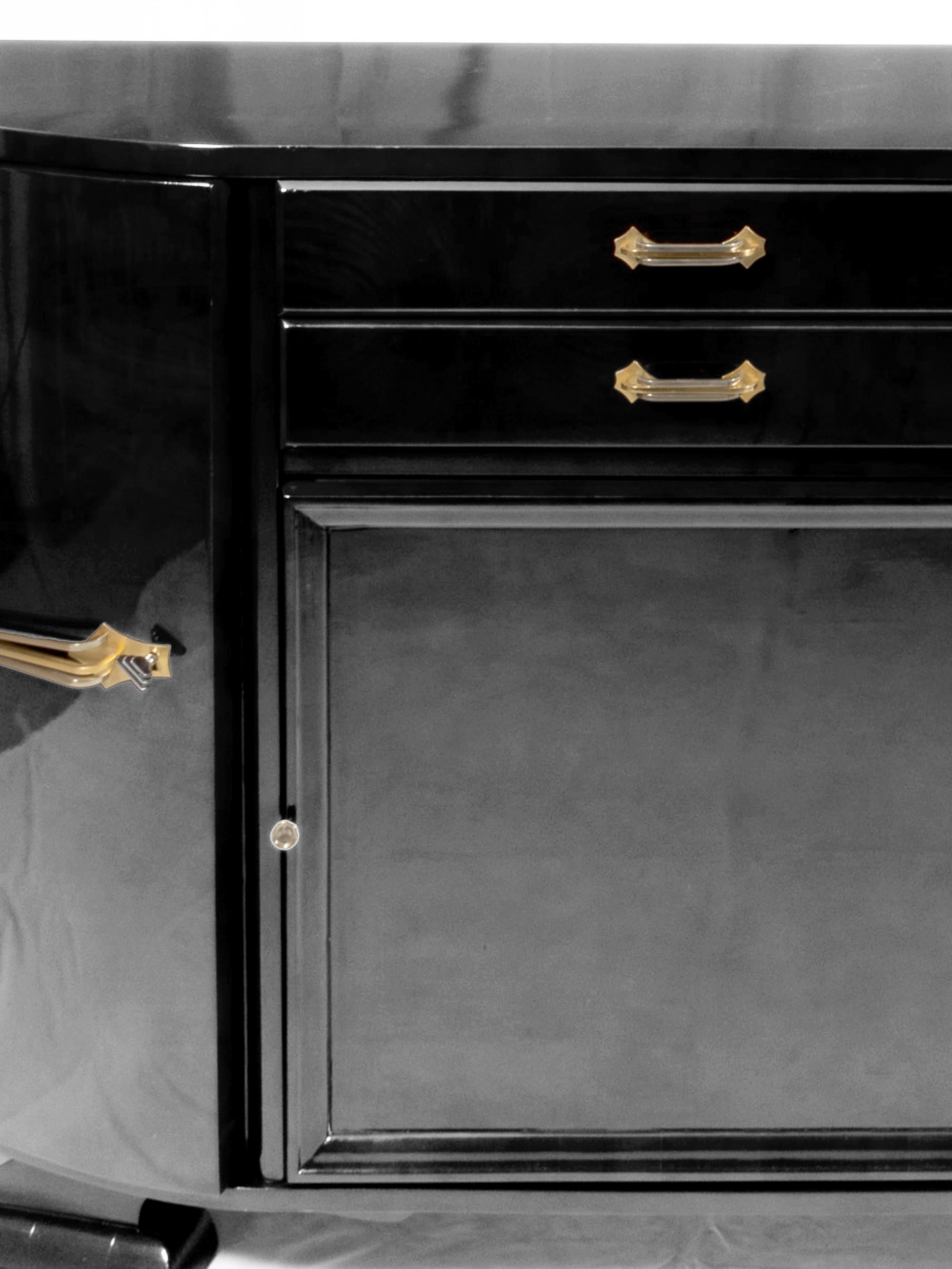 Una credenza eccezionale e sofisticata, che mette in mostra una squisita lavorazione artigianale e un'elegante ferramenta cromata e laccata nera. Questo straordinario pezzo, creato nella prima metà del XX secolo, vanta due cassetti superiori e un