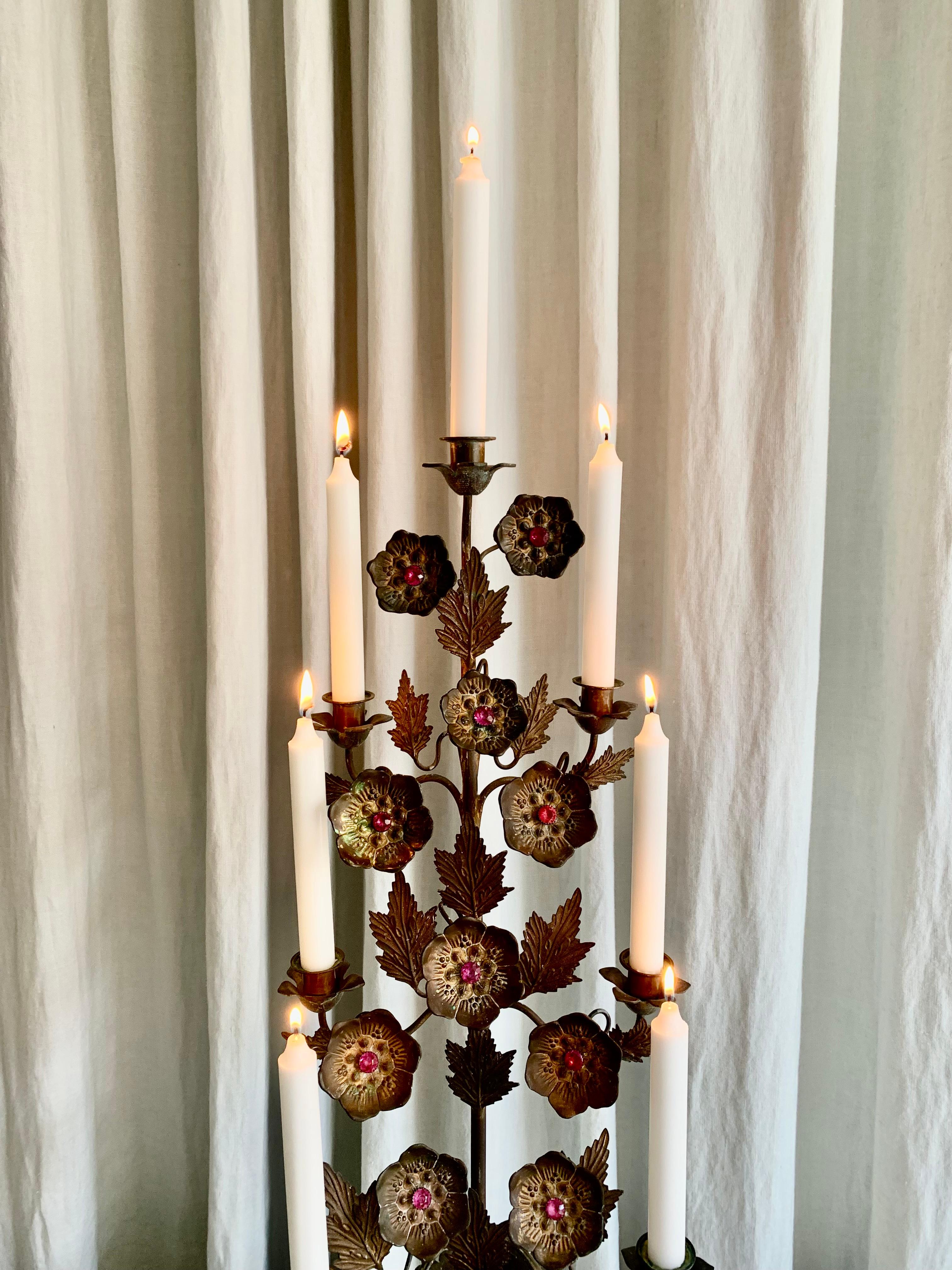 Large antique French gilt church candelabra with pink glass stones on the decorative poppy flowers. The candelabra has beautiful patina according to age and use and can hold 7 candles.
