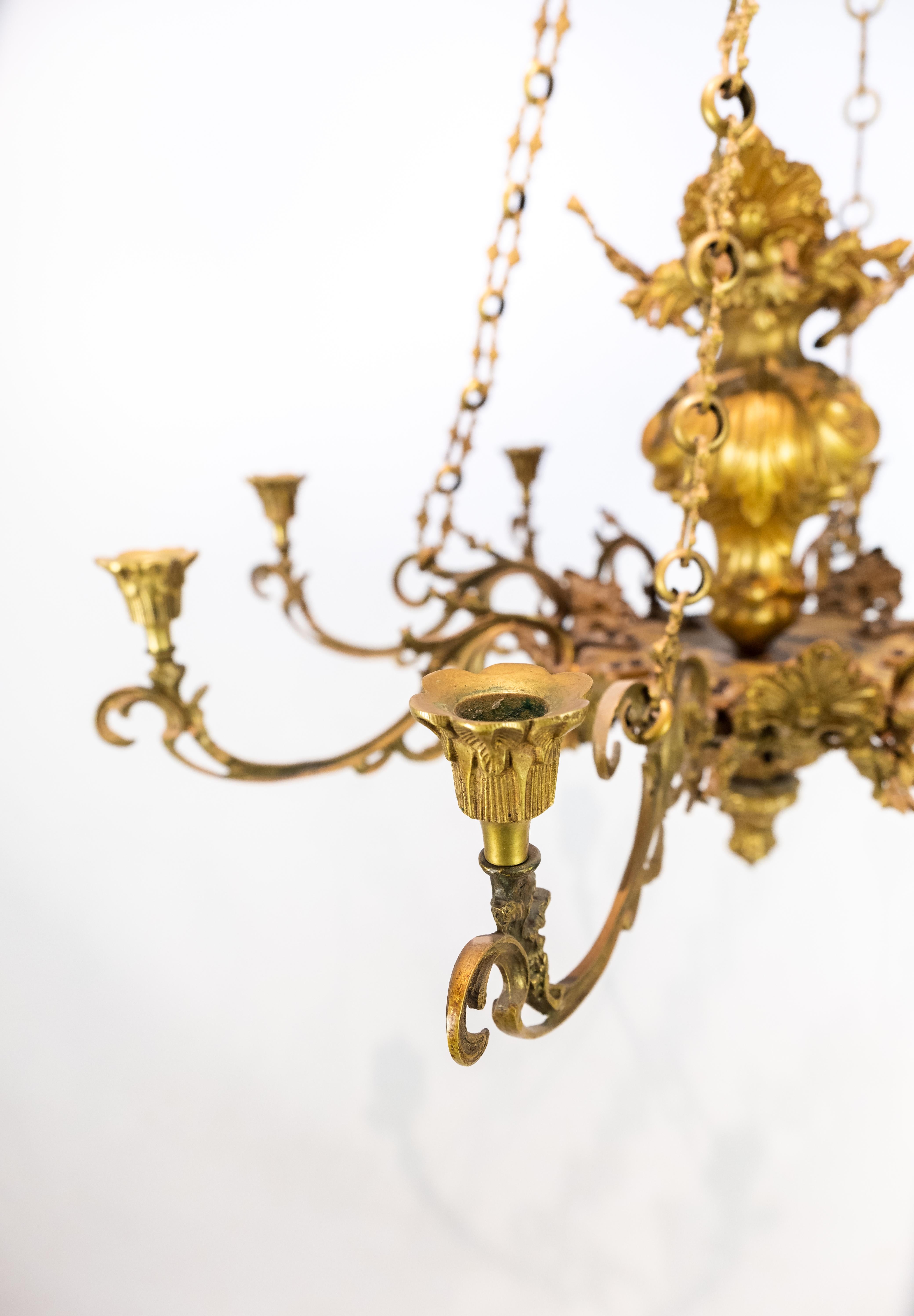 French church chandelier of bronze with beautiful decorations and eight arms for candle lights from circa 1880s. The chandelier is in great antique condition.