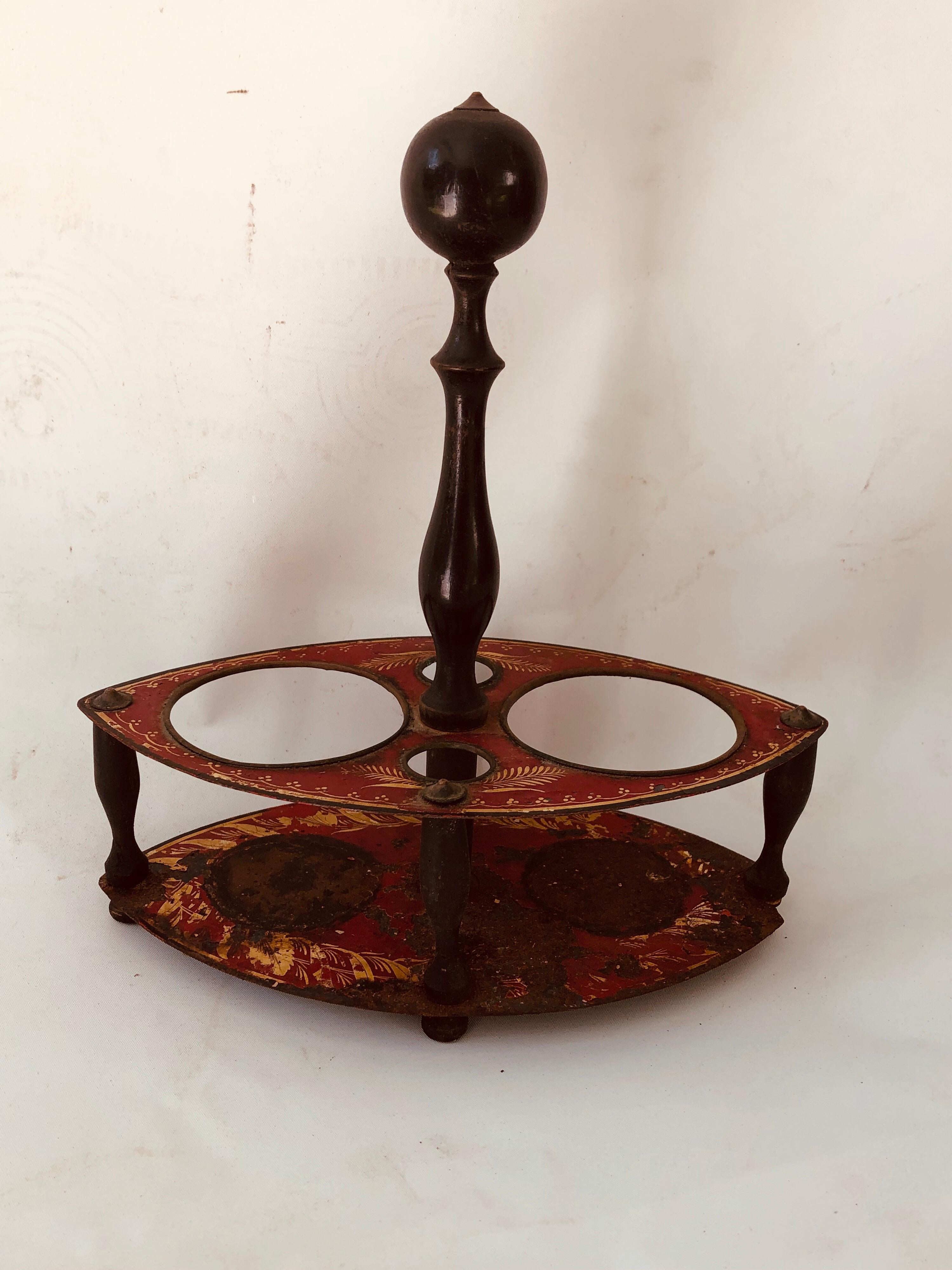 French late 18th-early 19th century tole red painted, with gold decoration, oil and vinegar holder. Also would have held other condiments. On wooden legs and carrying post, circa 1820.