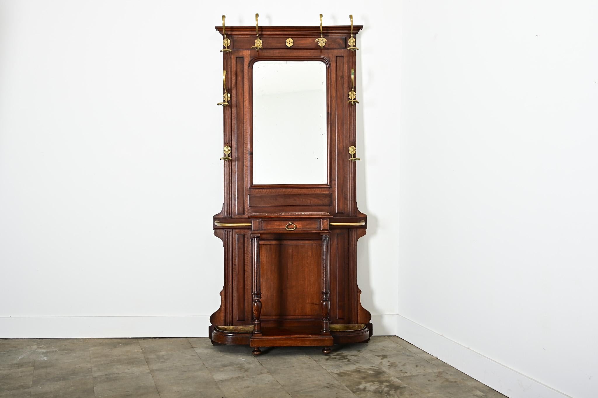 A multipurpose French vestiaire (hall tree) of circa 1920 that will serve many functions in an entryway or other active room in the home that needs compact storage solutions. This tall coat & hat rack is made out of solid mahogany, arranged in a