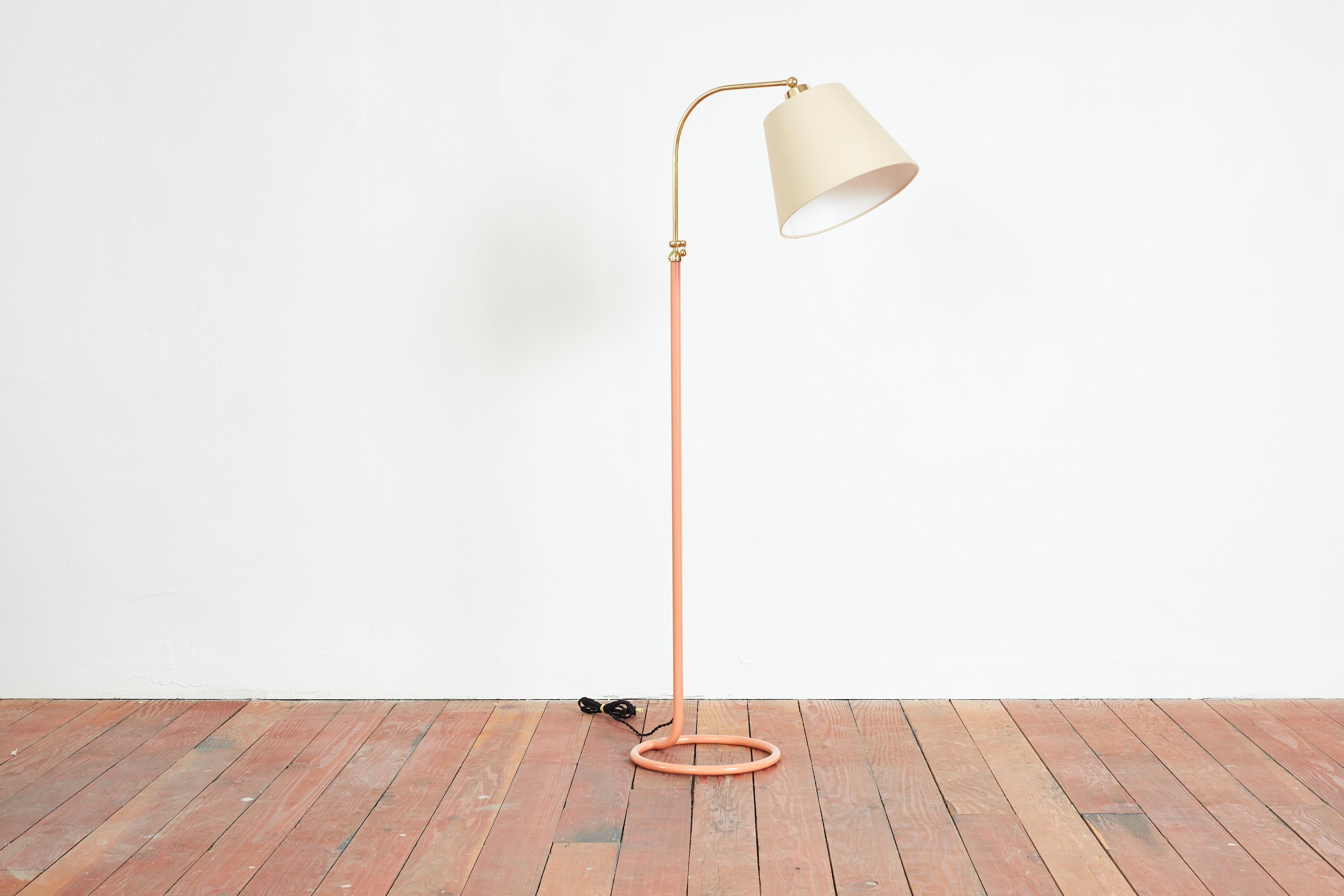 1940s French Floor Lamp with circular iron base 
Newly refinished with peach powder coated paint
New linen shade
Adjustable in height with brass hardware 
Height 54