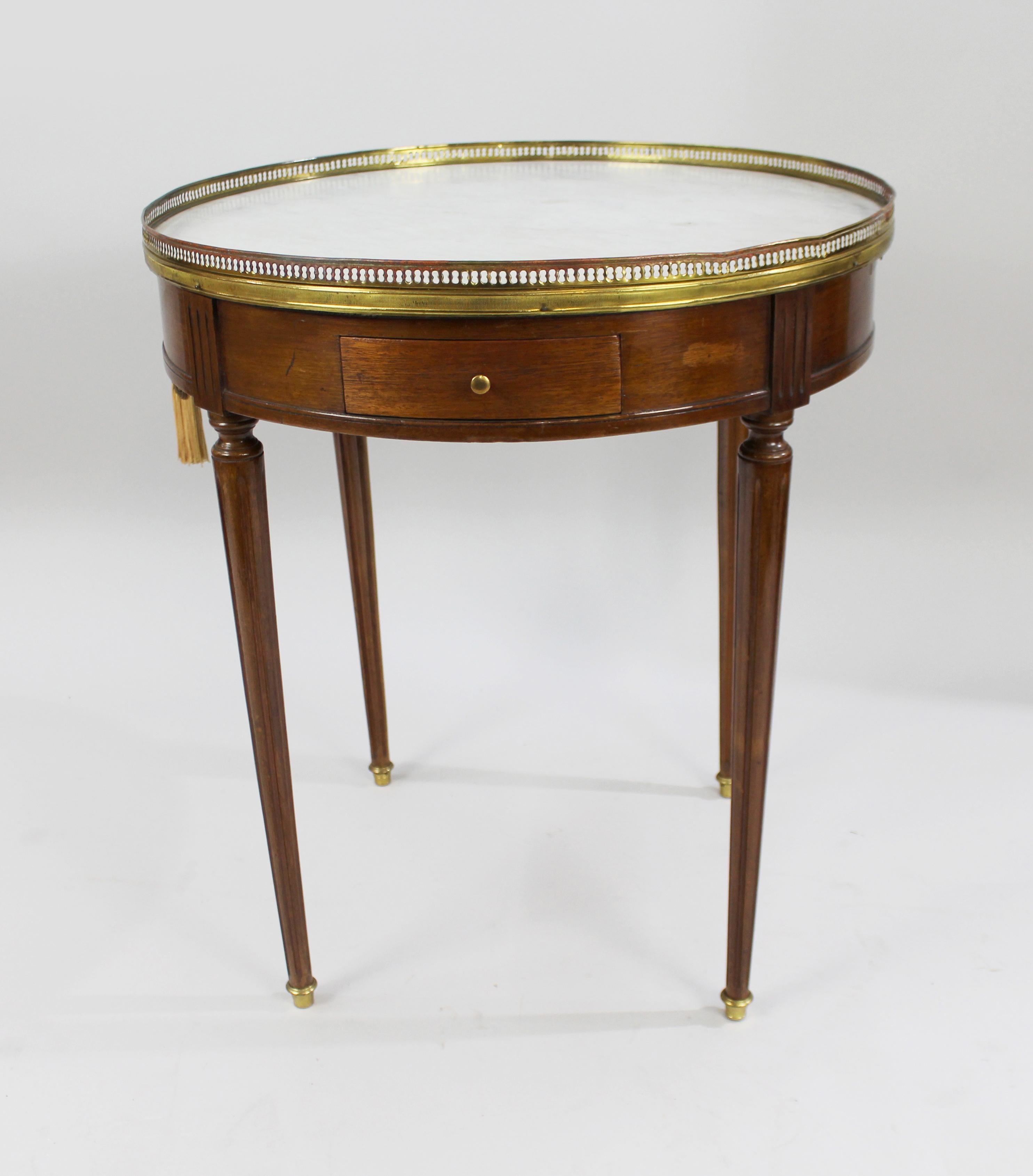 Period 
Vintage, early to mid-20th century, French

Wood 
Mahogany

Marble 
Circular Carrara marble top

Condition 
Sound structure. A few marks to marble top. Some little distortion to brass gallery top and wear to gilding. A few marks to