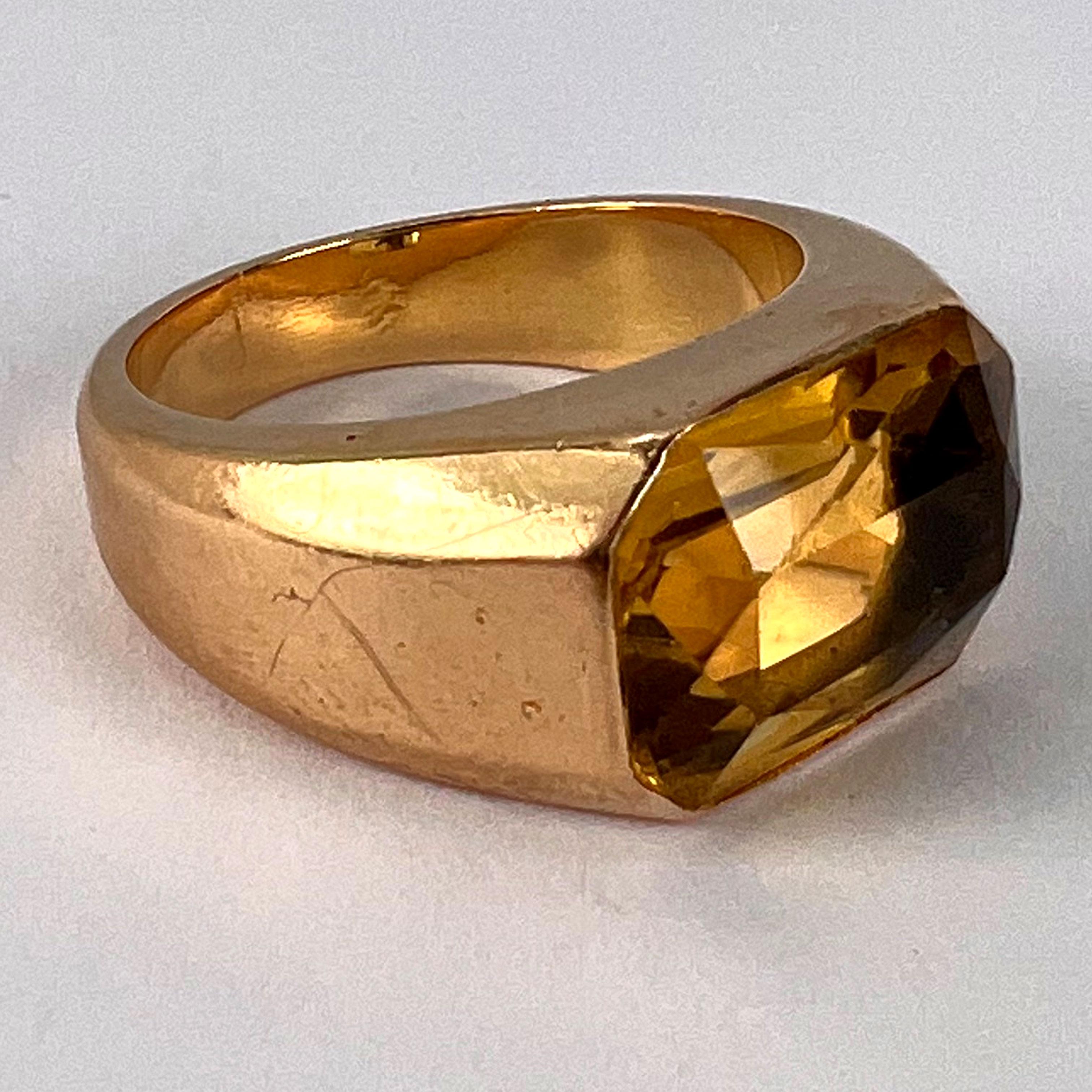 An 18 karat (18K) yellow gold ring in the Retro Tank style set with a scissor cut citrine with an approximate weight of 6.05 carats. The ring is stamped with the eagle’s head for French manufacture and 18 karat gold with a partial unknown maker’s