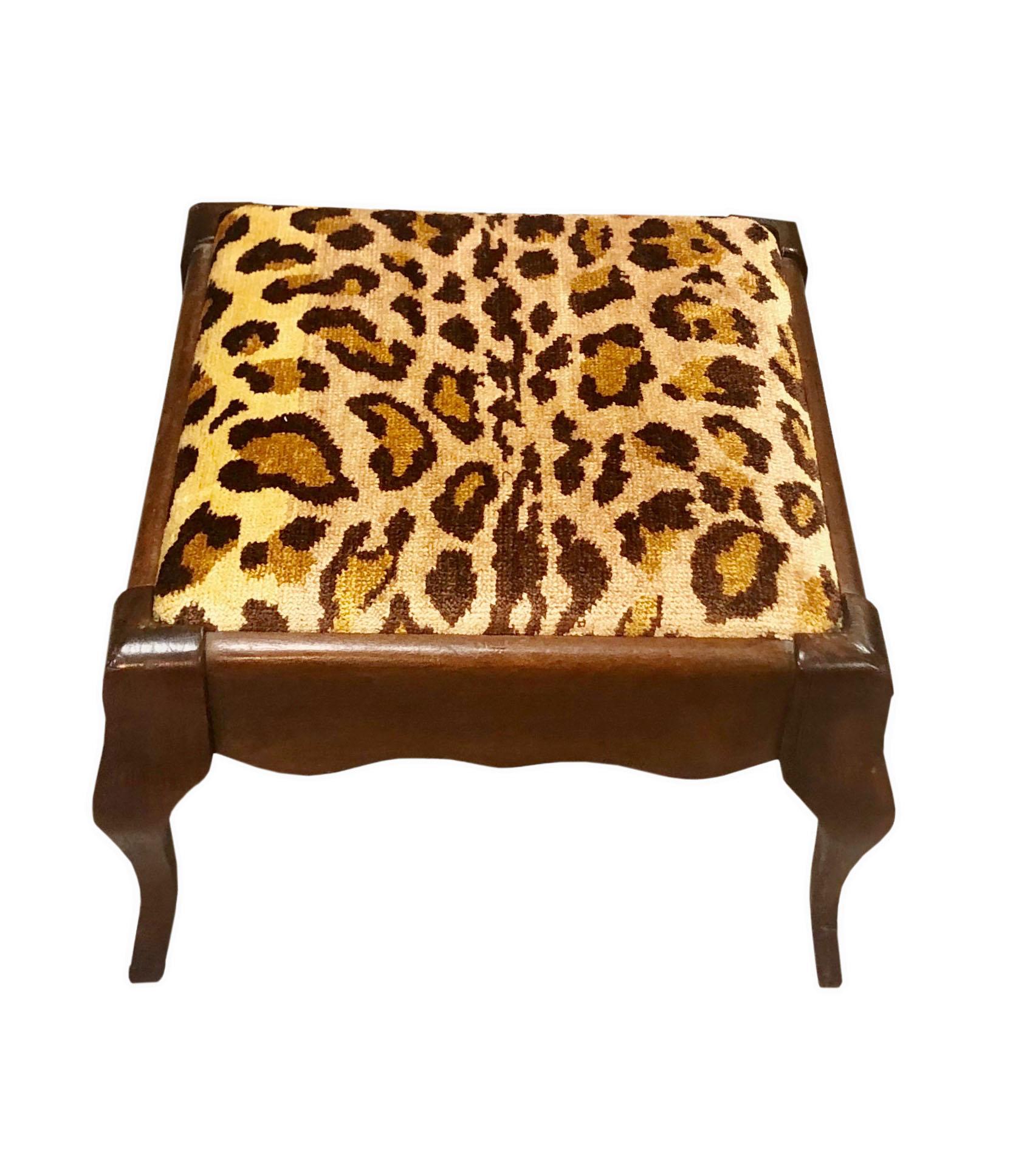 A vintage French foot stool upholstered with vintage 1970s, silk velvet animal print fabric by Clarence House. Circa 1940s.