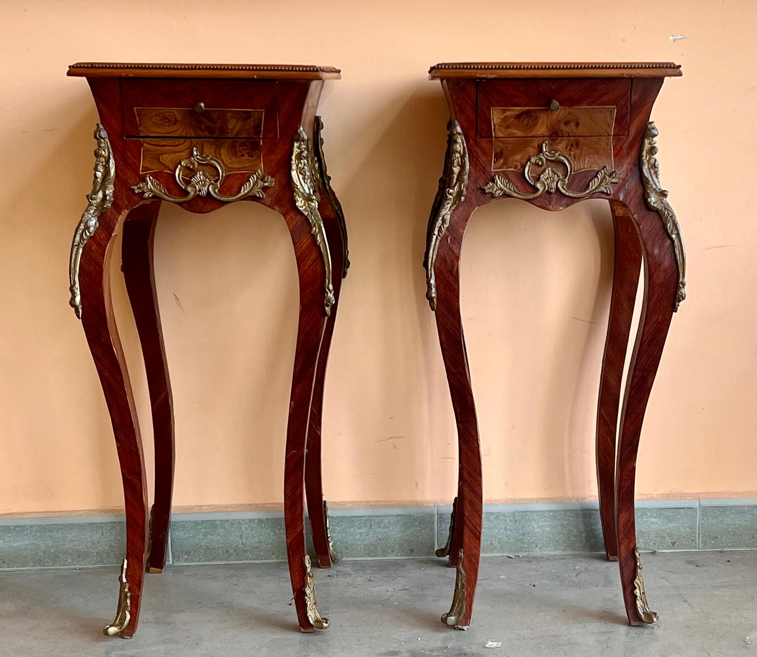 Pair of French Louis XV style nightstands with gorgeous floral and herringbone marquetry, herringbone inlaid box, gilt bronze mounts, one drawer with original bronze pulls and elegant legs with French kickstands and bronze trim.