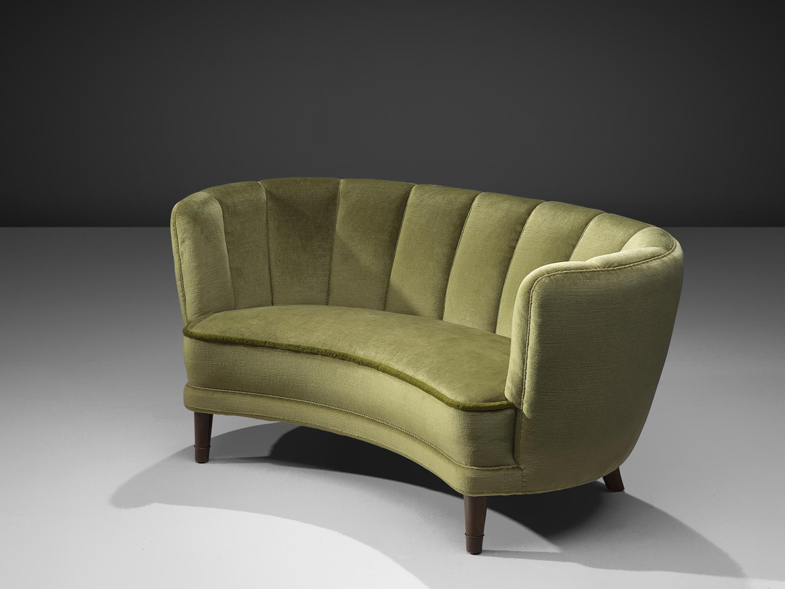 Sofa, green velvet and oak, France, 1950s

This voluptuous sofa is executed with wooden legs and shimmering green colored velvet fabric. The sofa has a high webbed, curved back and a thick body, both the back that flow into the armrests is bulky