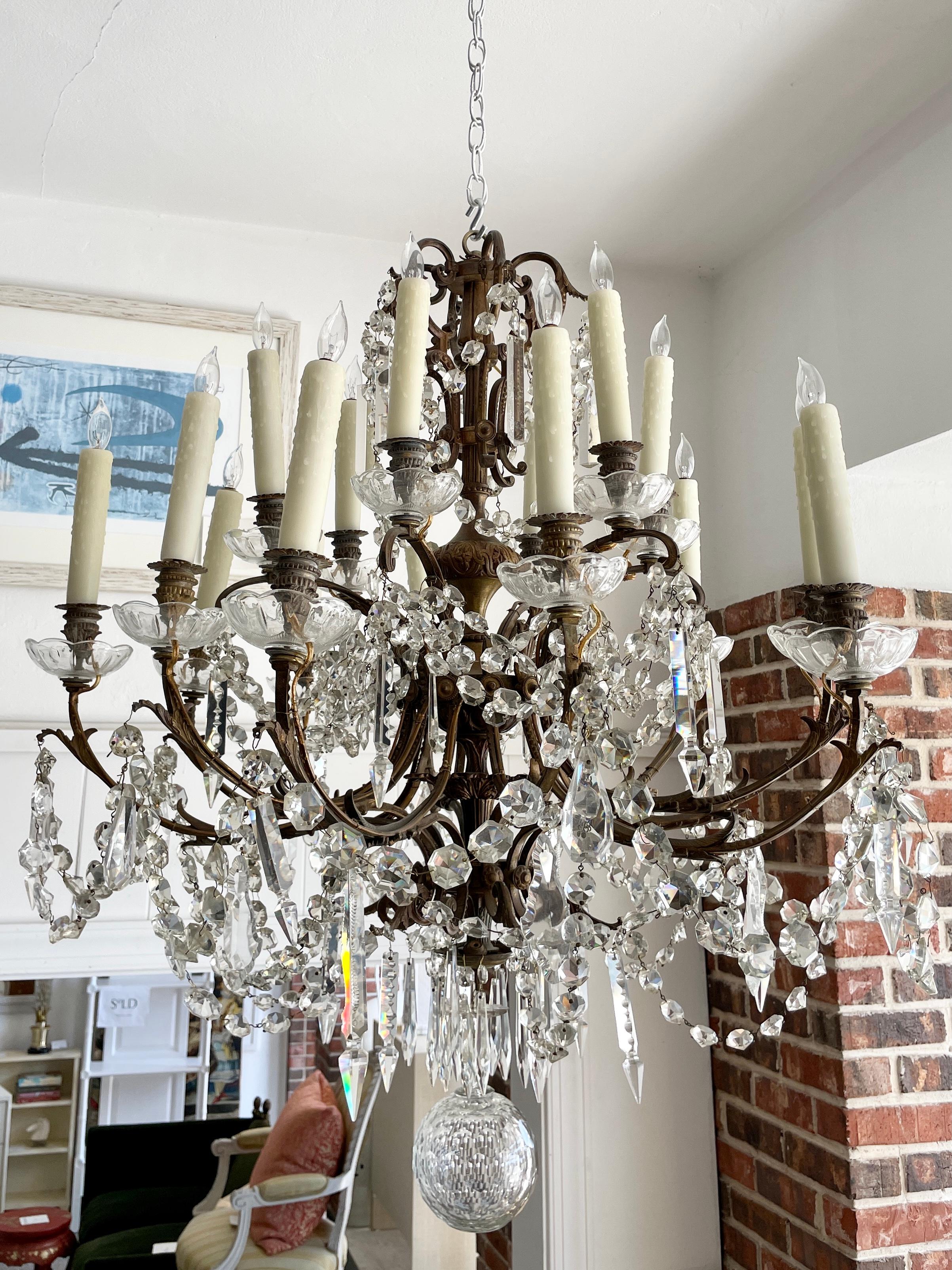 Beautiful large French Classical bronze and crystal chandelier. Very Large scale and large crystal elements not restored all original condition so there are minor chips and hanging details with crystal pieces. It's all consistent with the non