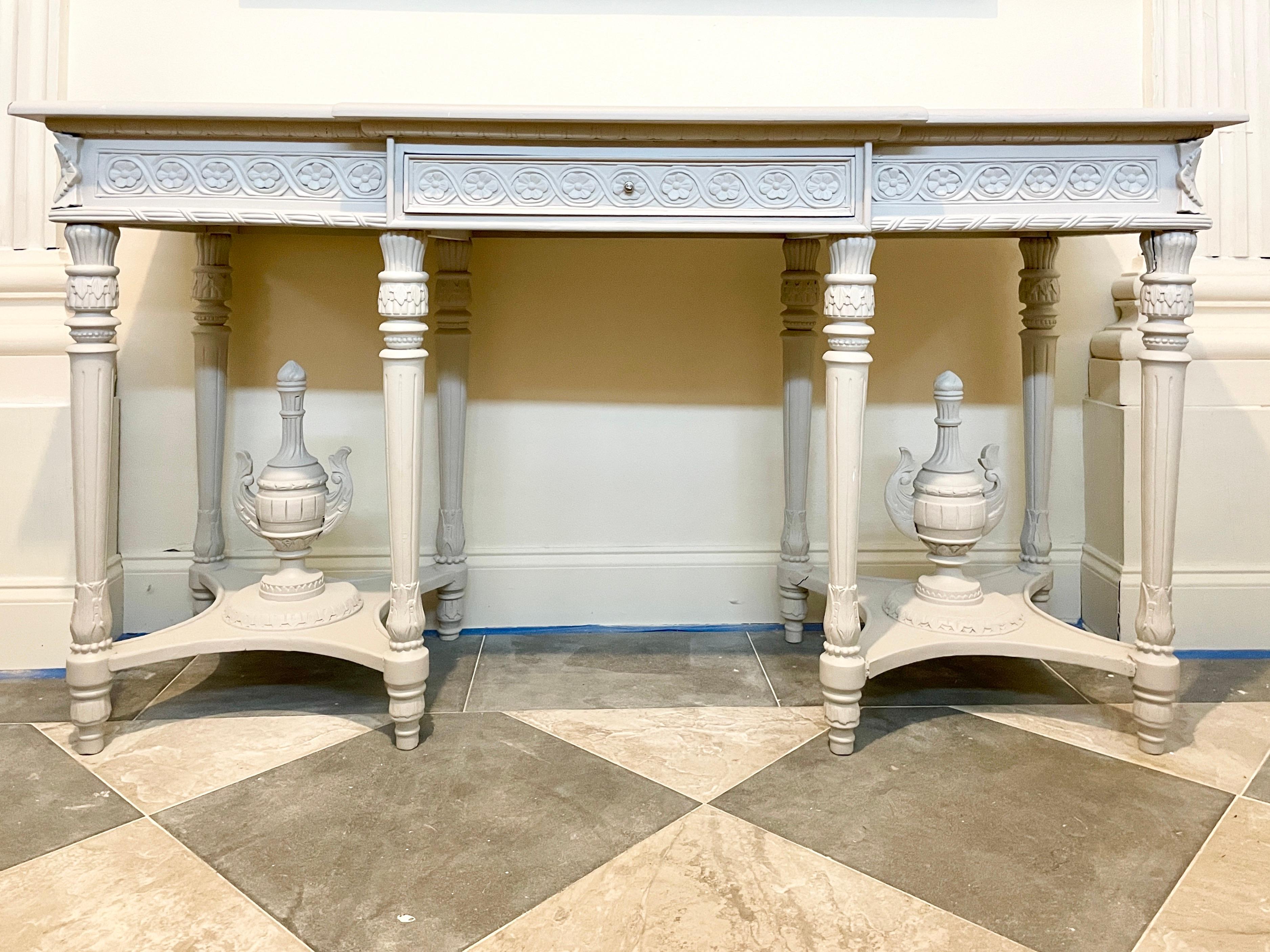Very French Classical console in painted gray finish with drawer. Beautiful carvings all over. It has nice age and is not perfect but has great character for its age. Add some French Architecture to your home with this gorgeous console.