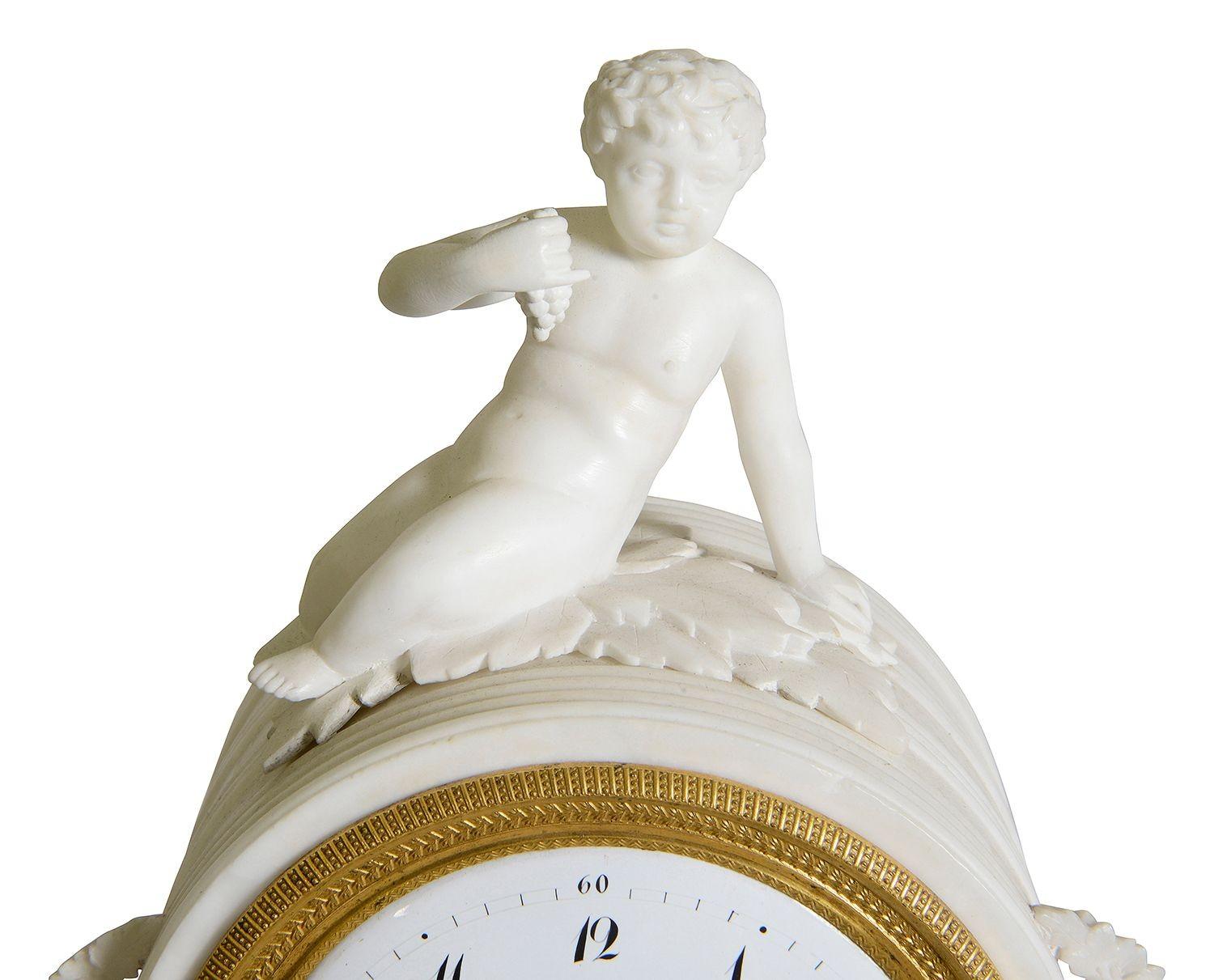 This elegant 19th-century French classical mantle clock, crafted from white marble, features an 8-day striking movement, showcasing both beauty and functionality. The clock is adorned with intricate detailing, including a charming figure atop the