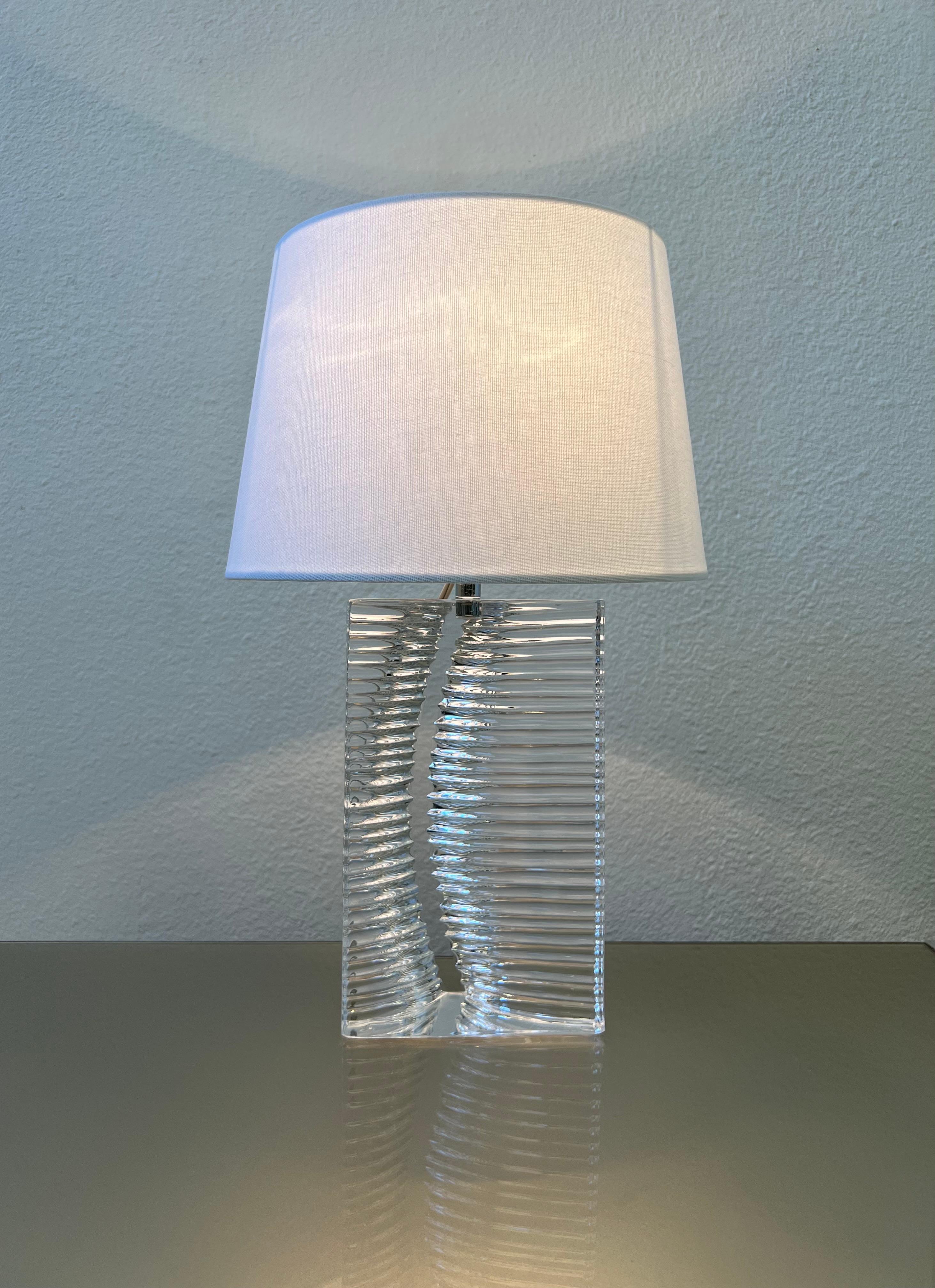Beautiful 1960s small French crystal table lamp by Daum. 
Hand Signed Daum France on bottom corner. 
In original vintage condition with new white linen shade. 
It takes one 70w Max Edison light bulb. 
Measurements with shade: 16” high, 10”