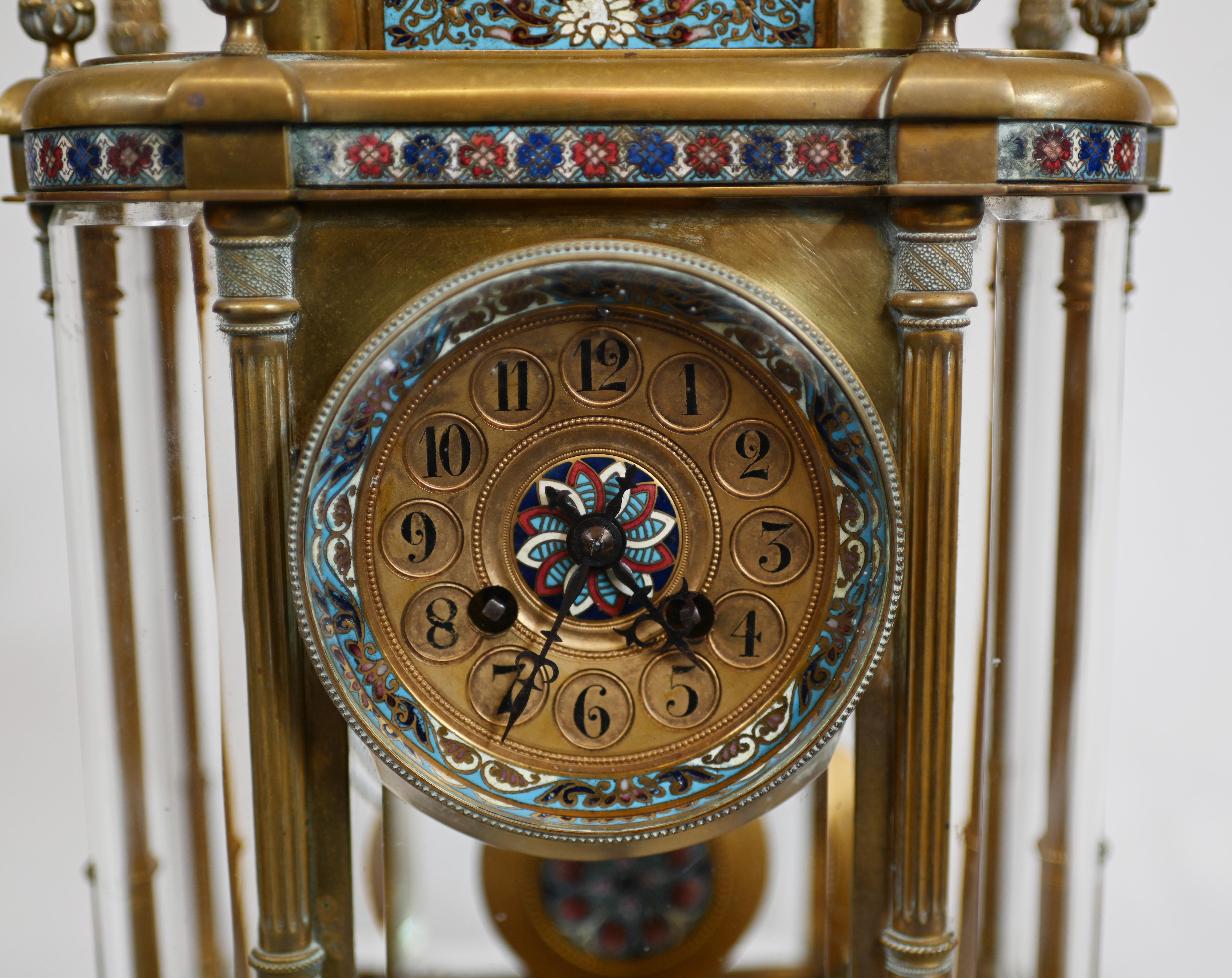 Gorgeous antique French three piece clock set
Mantle clock is flanked by the two urns 
We date this to circa 1860
Set features intricate champleve designs on all surfaces
Champleve is a decorative technique that fuses a powdered glassy material