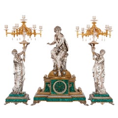 French Clock Set in Malachite, Gilt and Silvered Bronze