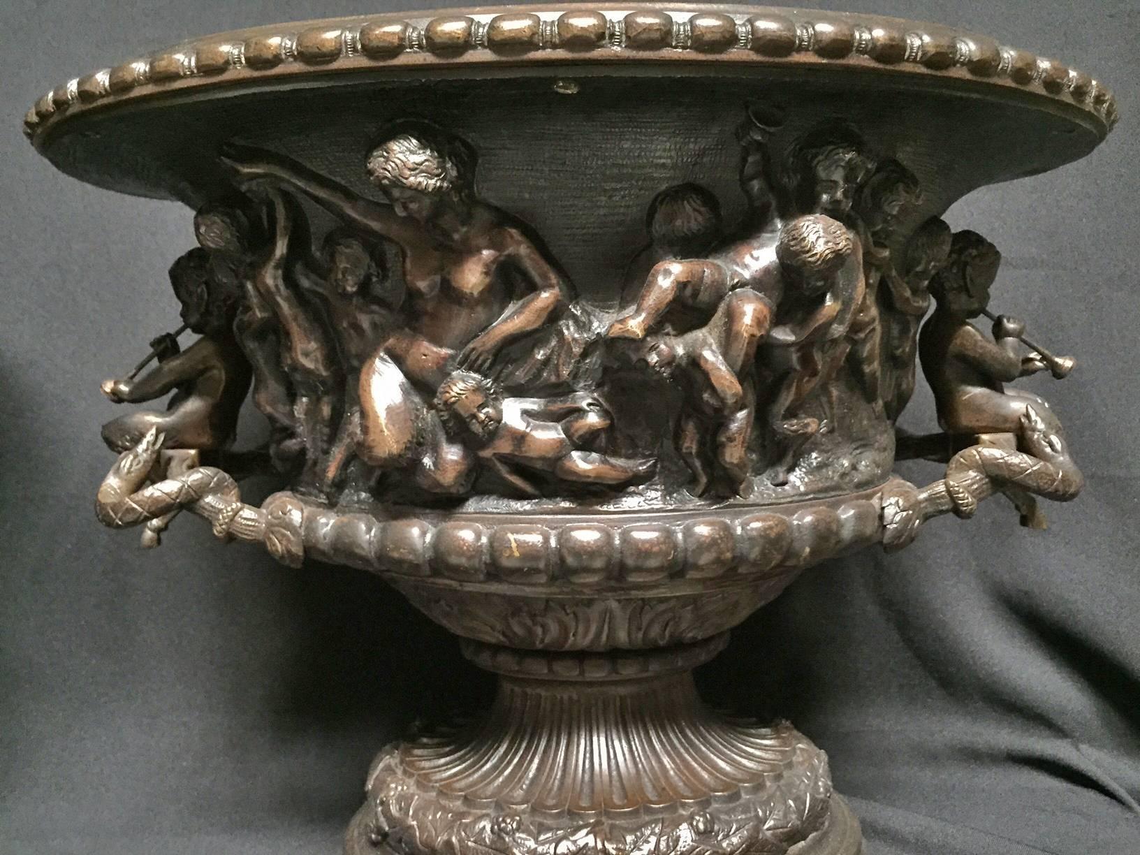 19th century impressive large French Clodion style oval centerpiece with cherub handles. The gadrooned edge over a detailed frieze of frolicking putti with grapes and musical instruments. The finely cast pedestal base is in great proportion to the