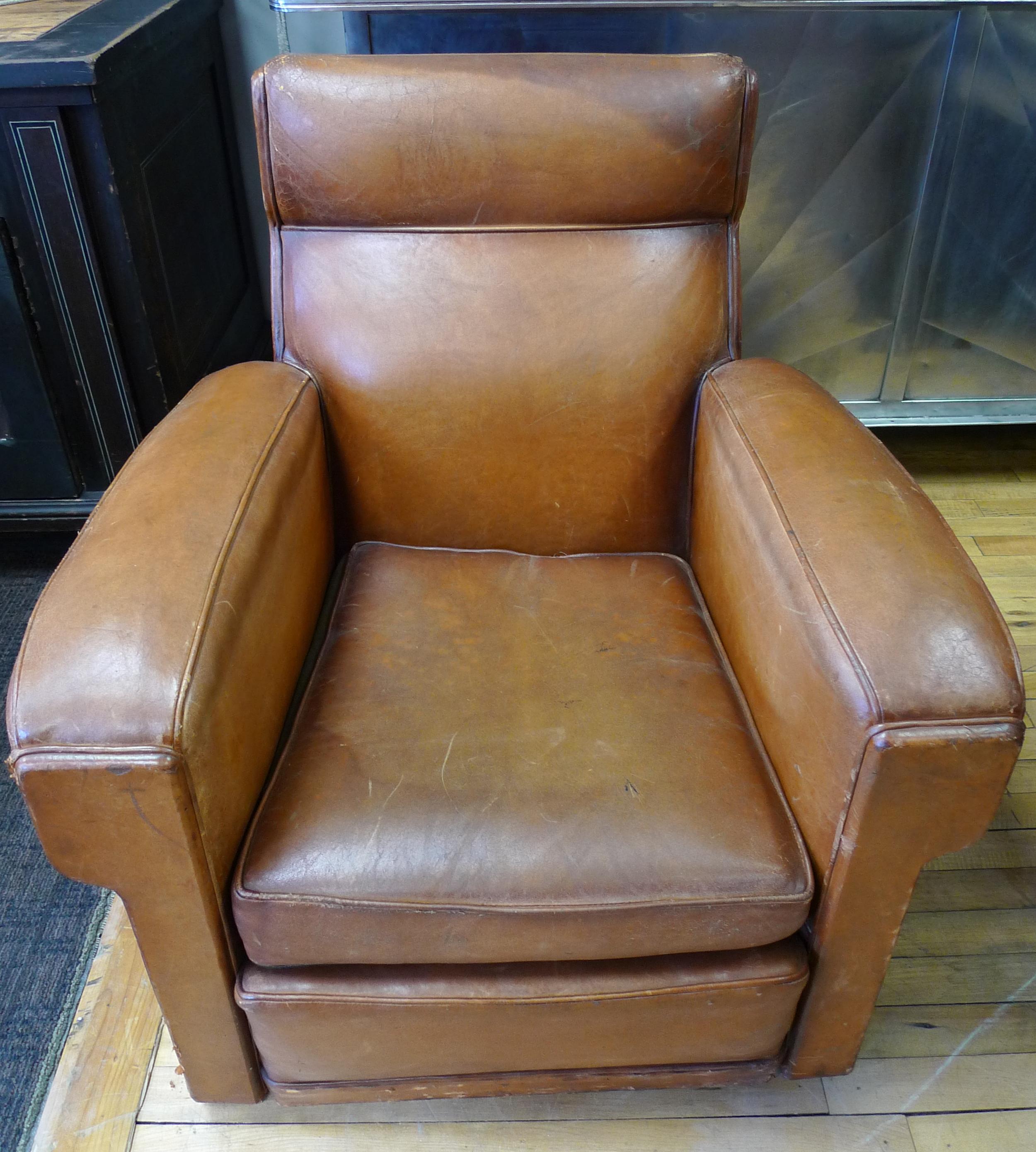Club sofa lounge chair from France of brown leather, circa 1930s. Spring supported, seat cushion makes for deeply luxuriant seating. Patina on leather is rich to the eye and sensual to the touch of the hand. Draws you into its remarkable pedigree