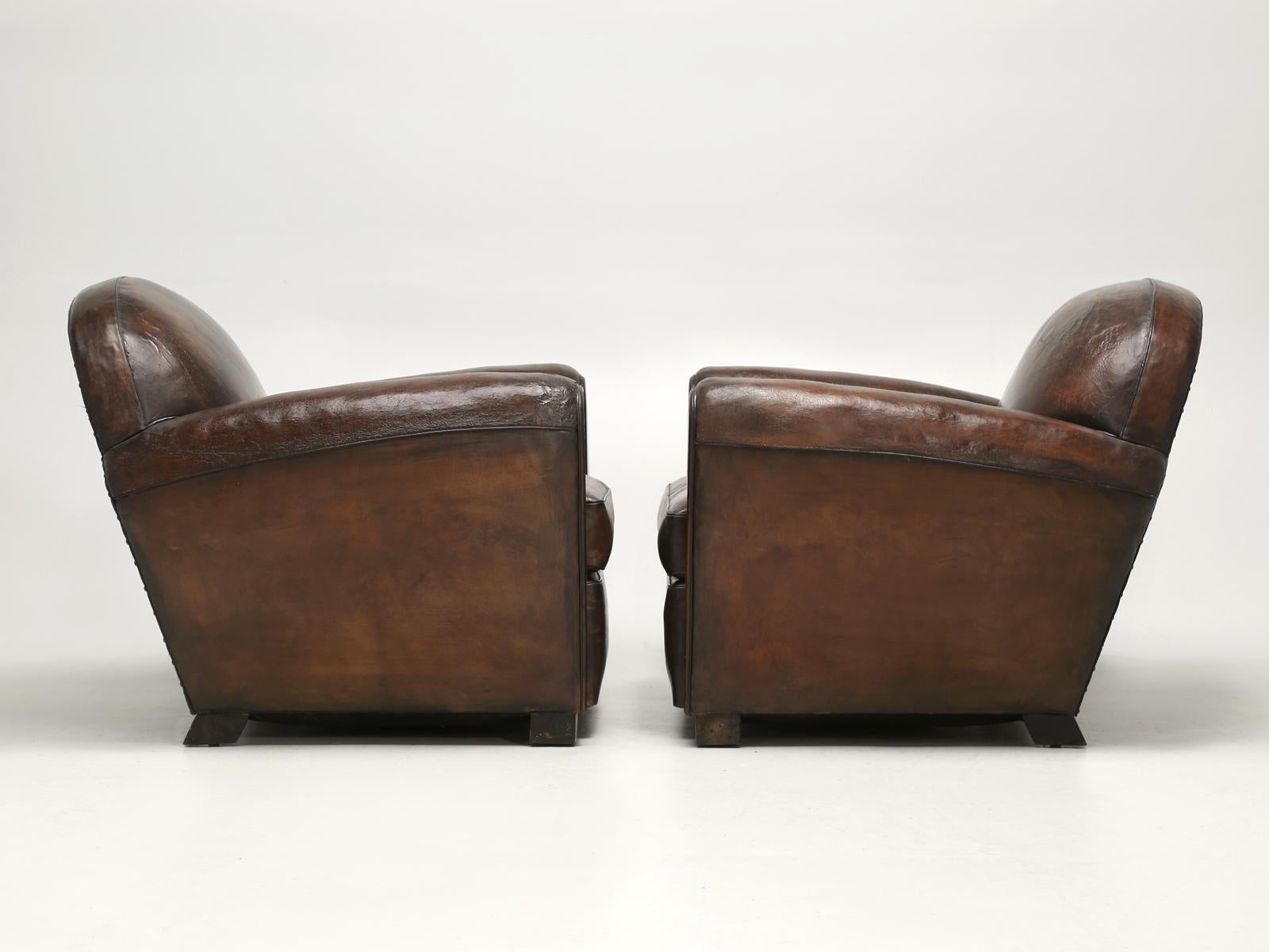 Old Plank has been specializing in the importation and restoration of French leather club chairs for over 30-years and we are still trying to improve our craft. These are a particularly early pair of French Art Deco club chairs, probably dating from