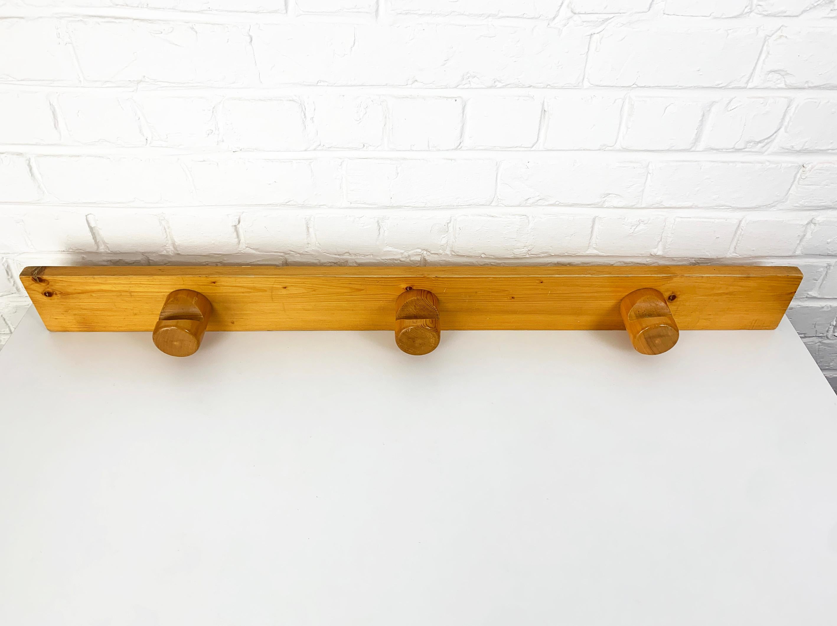 Coat rack with three hangers designed by Charlotte Perriand for Les Arcs, a ski resort in the Alps. 

The project was one of the largest in Perriand's career. She was then in her 60s, at the peak of her career in 1967 when she was asked to join the