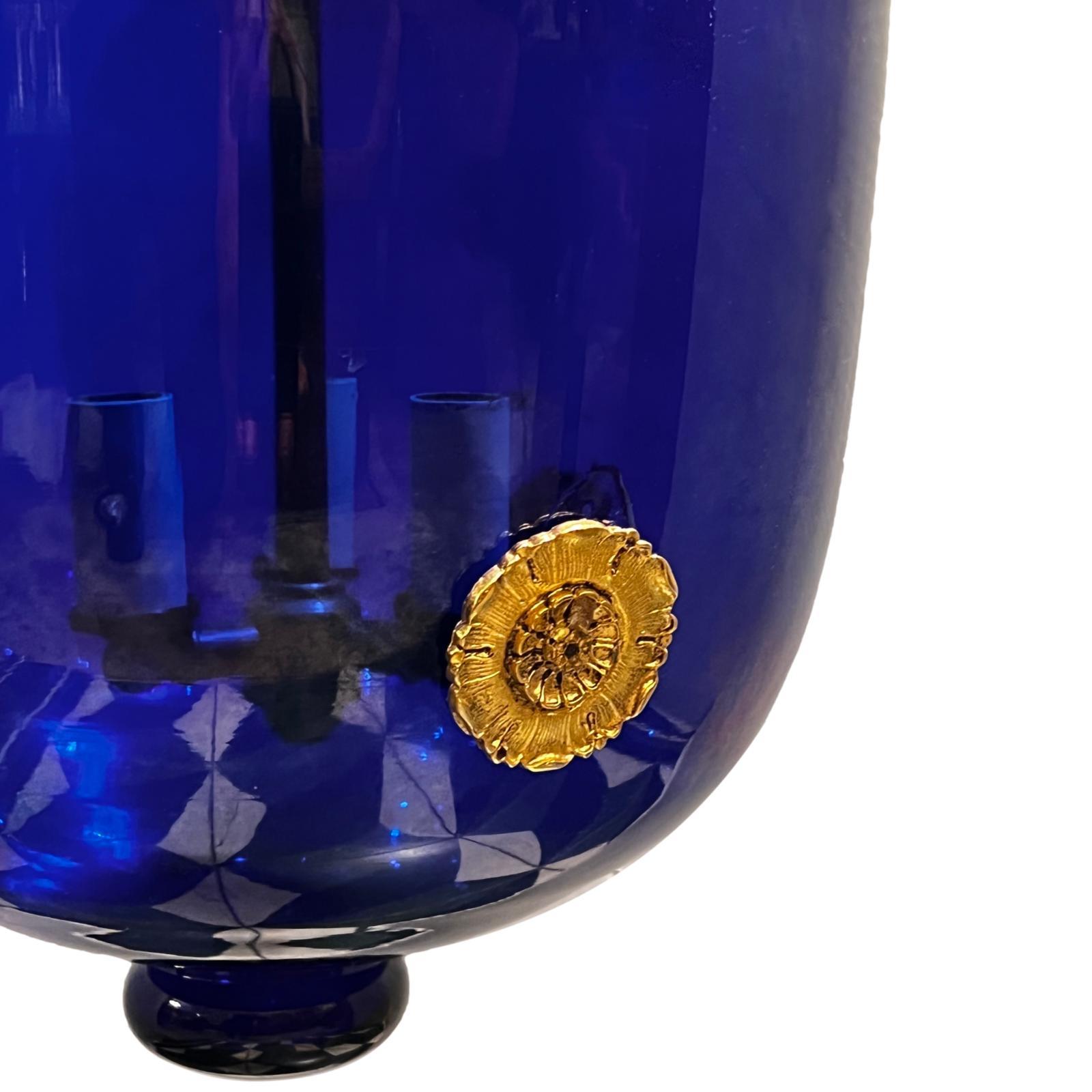 A circa 1960's French cobalt blue glass lantern with gilt bronze details and patinated hardware.

Measurements:
Drop: 21