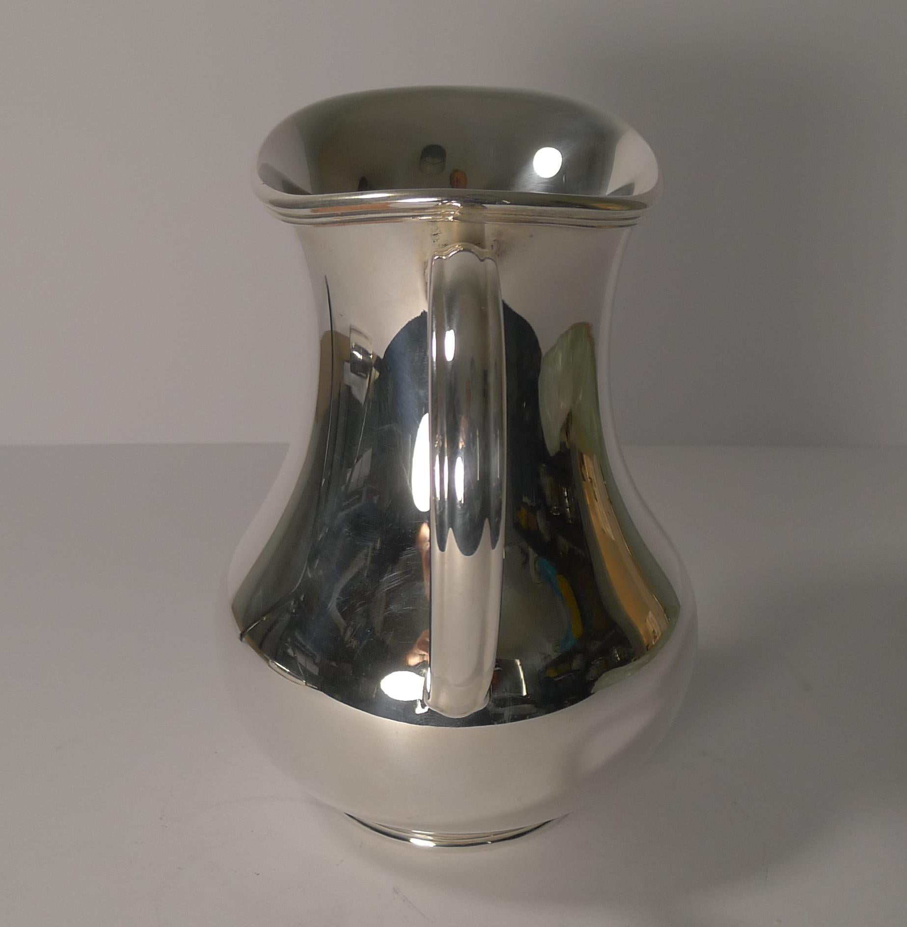 Dating to the 20th century, this Art Deco style jug or pitcher is perfect for your drinks tray or bar trolley.

It is fully marked on the underside for the top notch silversmith, Christofle, France.

Excellent vintage condition measuring: 6