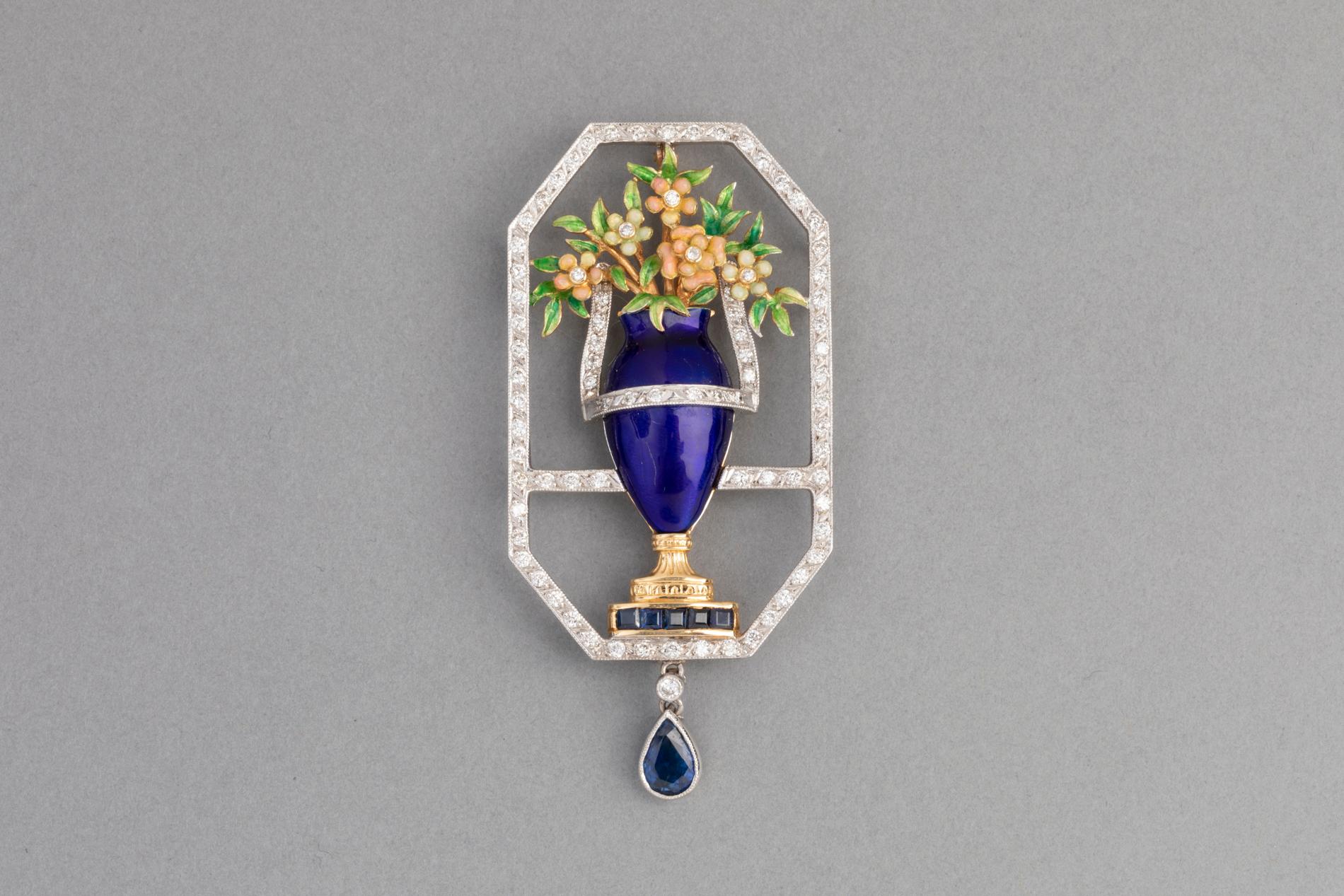 Very lovely Brooch, made in France circa 1950.

 Made in Yellow and white gold 750. French mark: Eagle, signature of the maker (unknown).  The design represent flower on a vase. 
The vase and the flowers are covered with bleu enamel in perfect