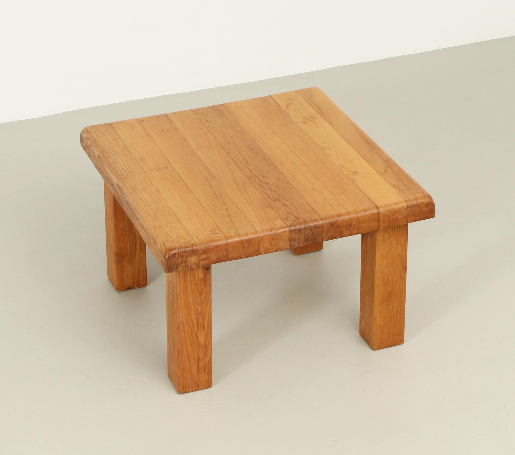 Square coffee or side table in solid oak wood, France, 1960's. Solid construction with four legs.