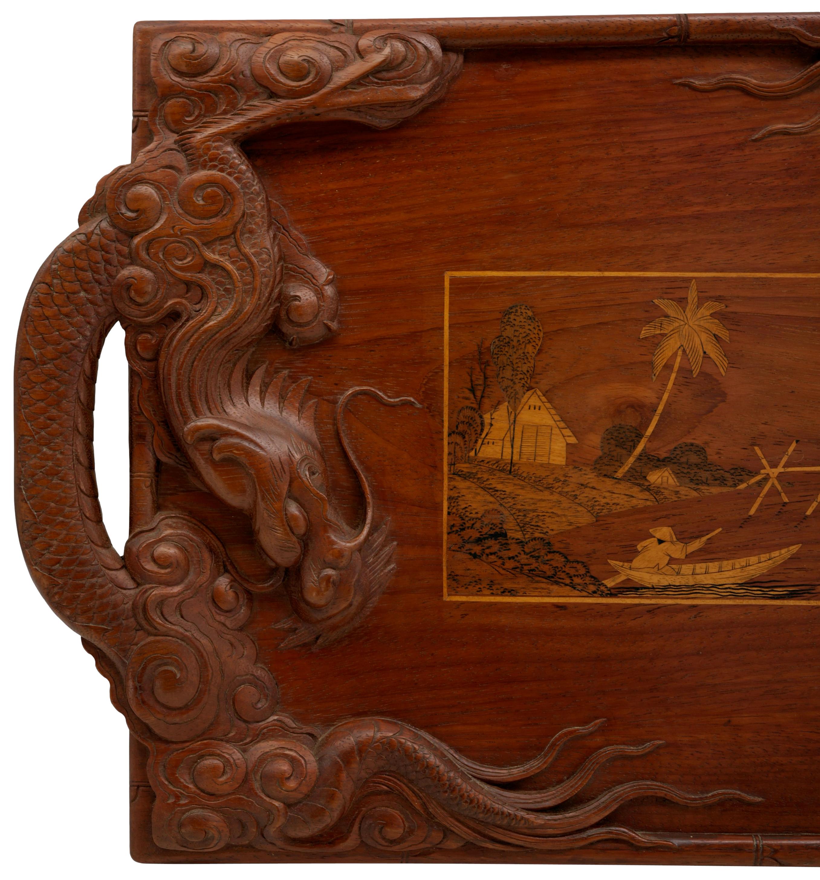 French colonial dragon tray, late 19th - early 20th. Carved and inlaid wood. Two remarkably carved and chiseled dragons forming handles, and a central reserve showing a delicately inlaid Asian scene. Measures: Width : 23.6