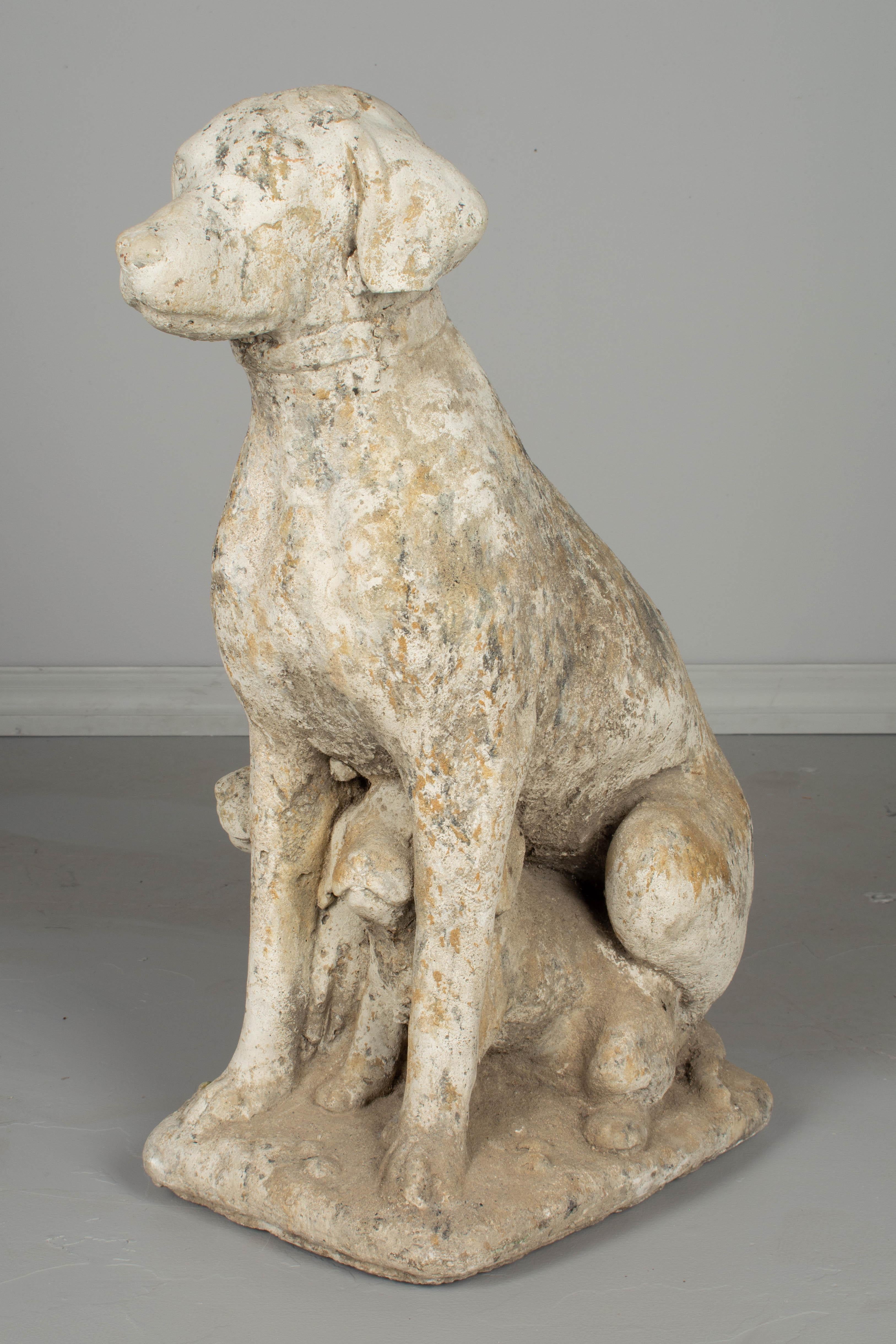 A 20th century Country French garden sculpture of a dog with a pair of puppies. Made of composite stone with old mossy patina. Weight: 150 lbs. Please refer to photos for more details. We have a large selection of French antiques at Olivier Fleury,