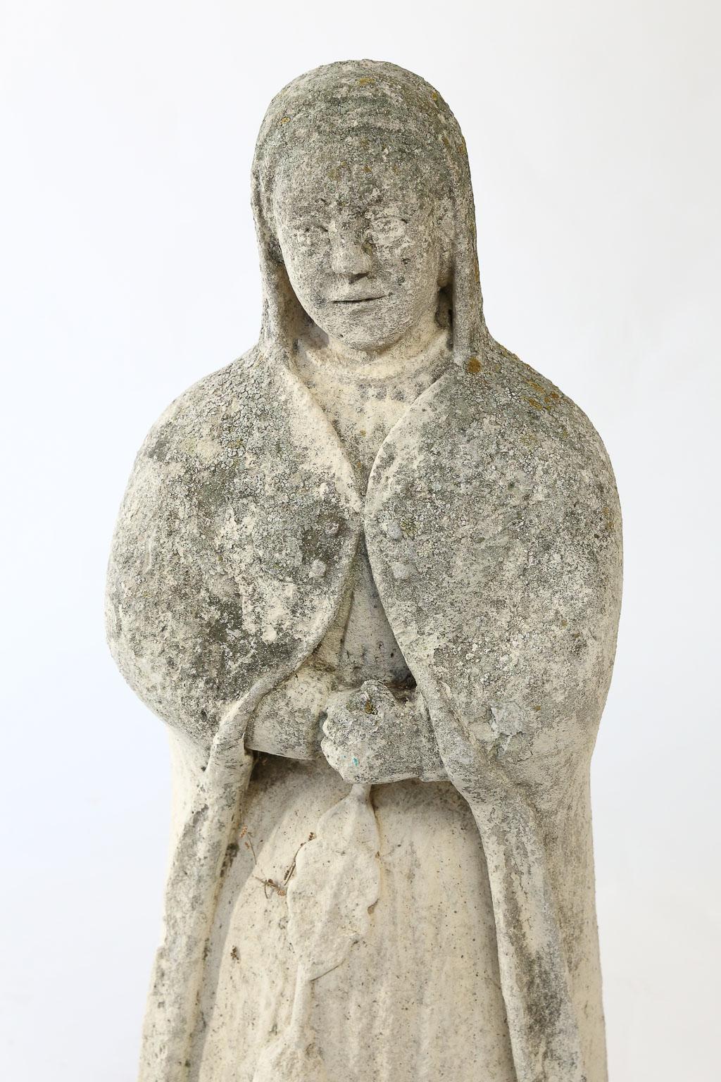 This beautiful concrete statue of a nun will be a lovely addition to your garden or home interior. The expression on her sweet face leads us to believe she is in deep prayer. As she was found in France we believe she is a replica of a French