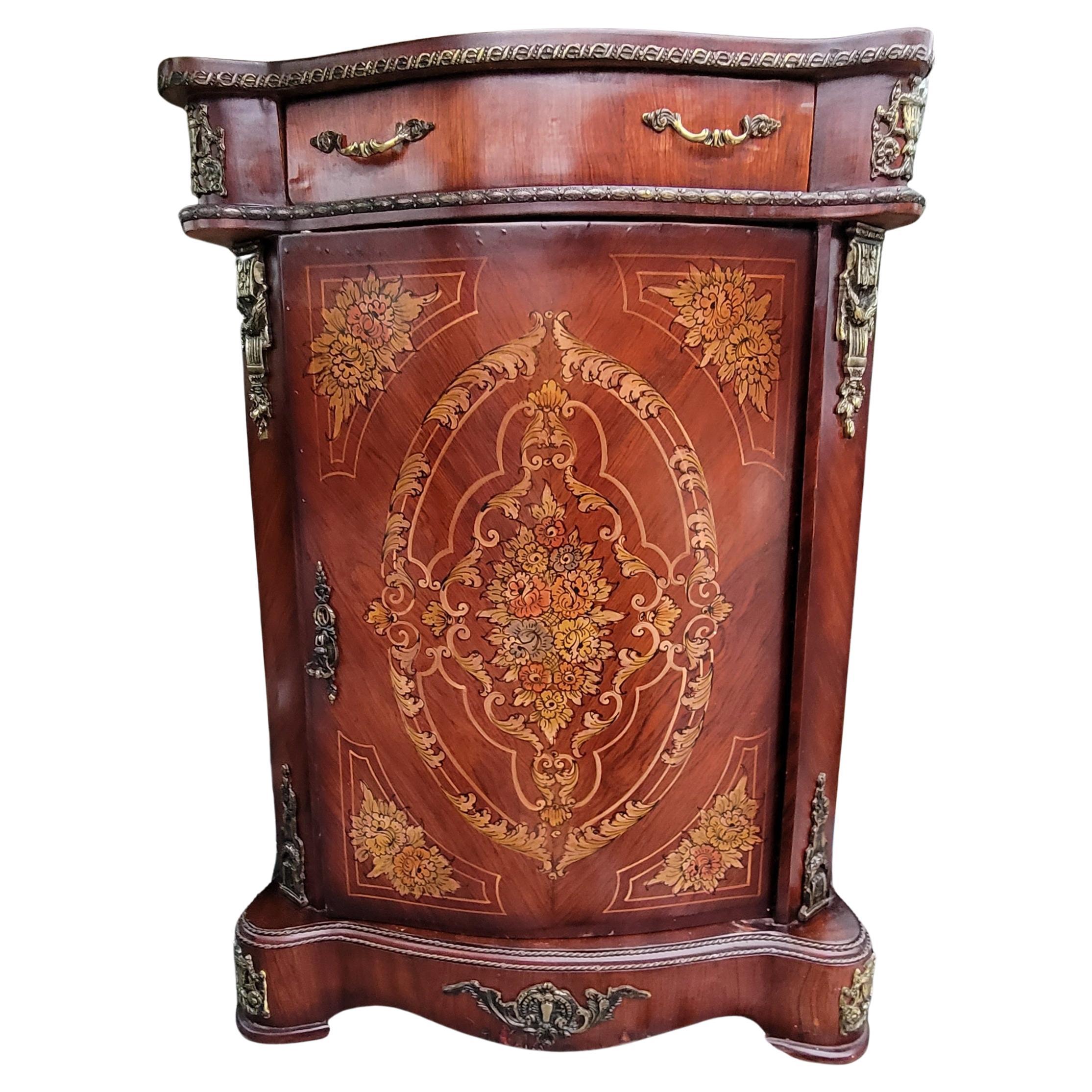 A 1940s French Continental Mahogany side console cabinet  with exquisite, finely detailed Marquetry works on the front and sides and with Metal and brass mounts and decorations throughout. Absolutely gorgeous console suited for your entry hall or