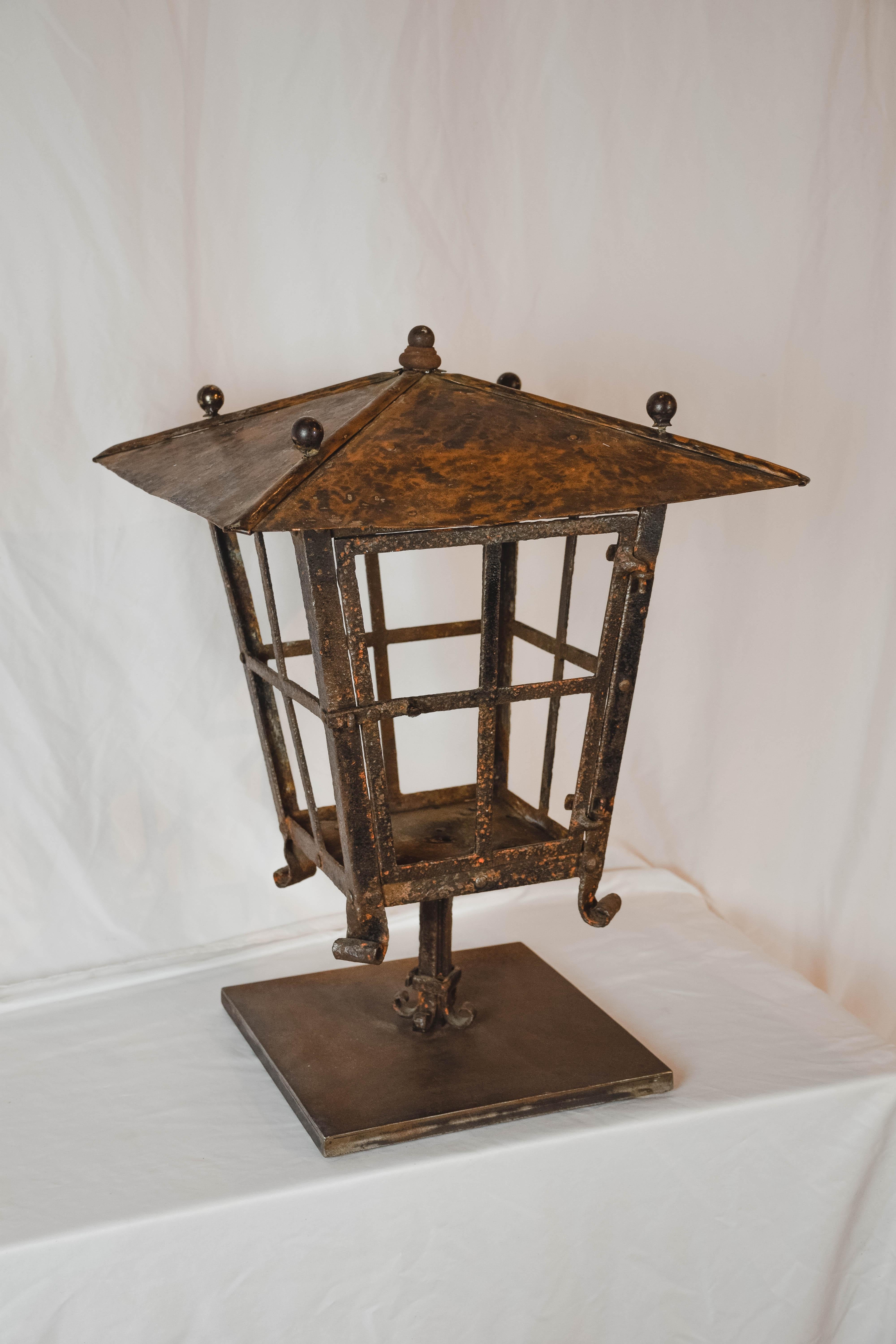 Charming French Antique copper lantern with metal base. The lantern, without glass, has a wonderful aged patina with some verdigris. Would look great with a large candle in it or could be converted into a table lamp. 

 