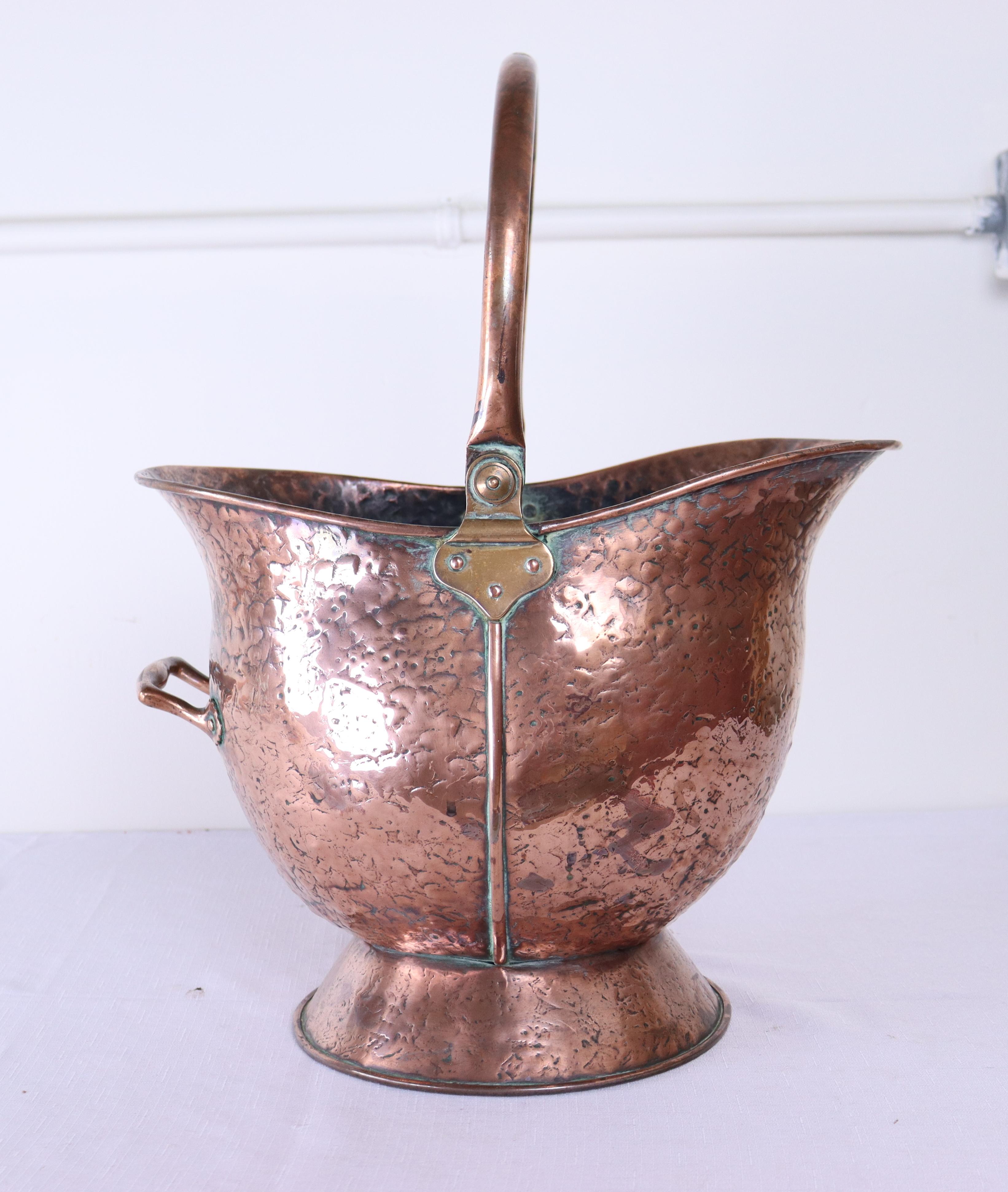 A wonderfully hammered copper log bin or pail from late 19th century France.  Height measurement is for the bin without the handle.