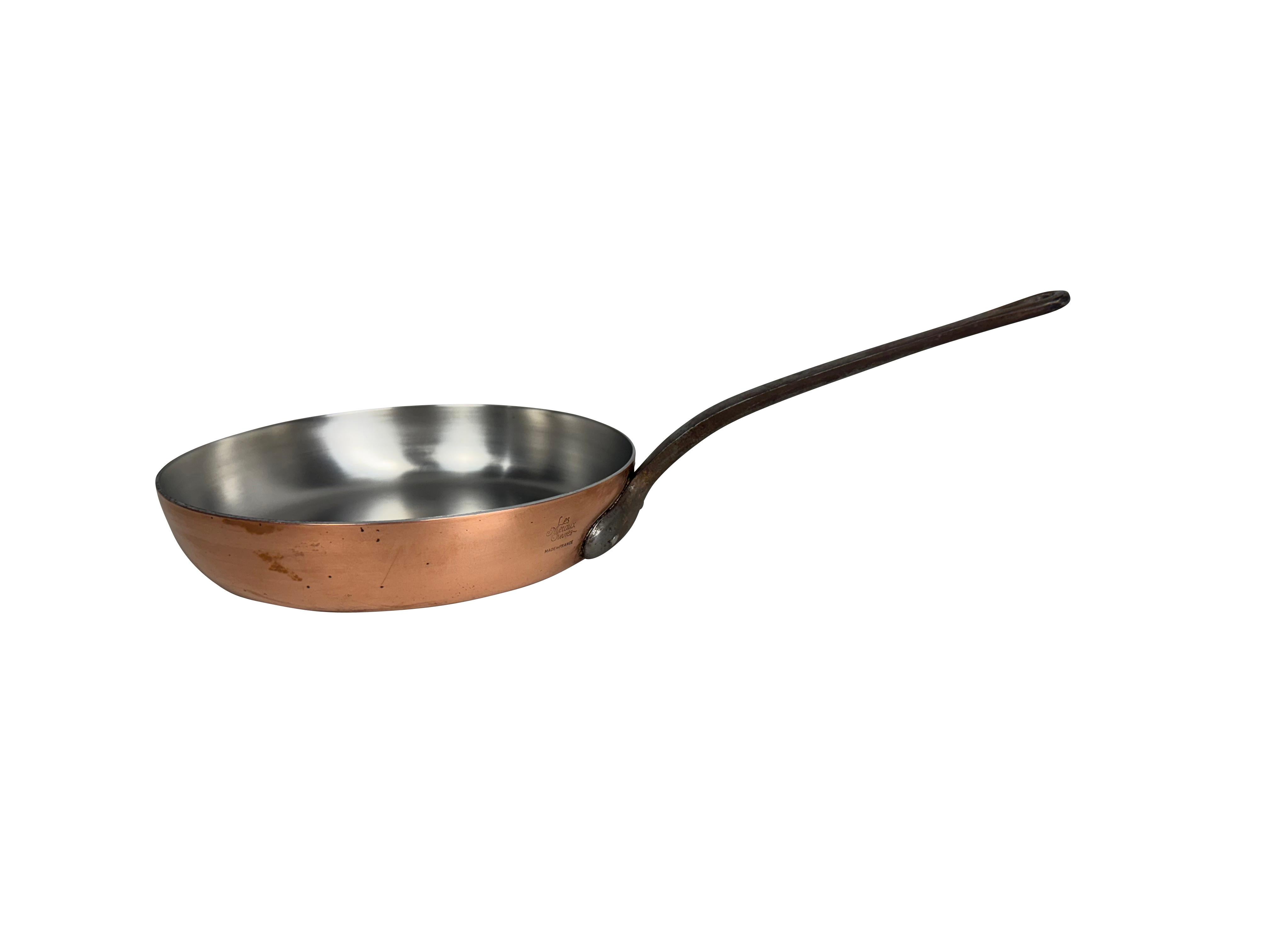 A 9-inch copper saucepan with an iron handle marked Metaux Ouvres, France. A must for your French-inspired kitchen. Made in the first half of the 20th century, this saucepan is in excellent vintage condition and is superb in its quality. The