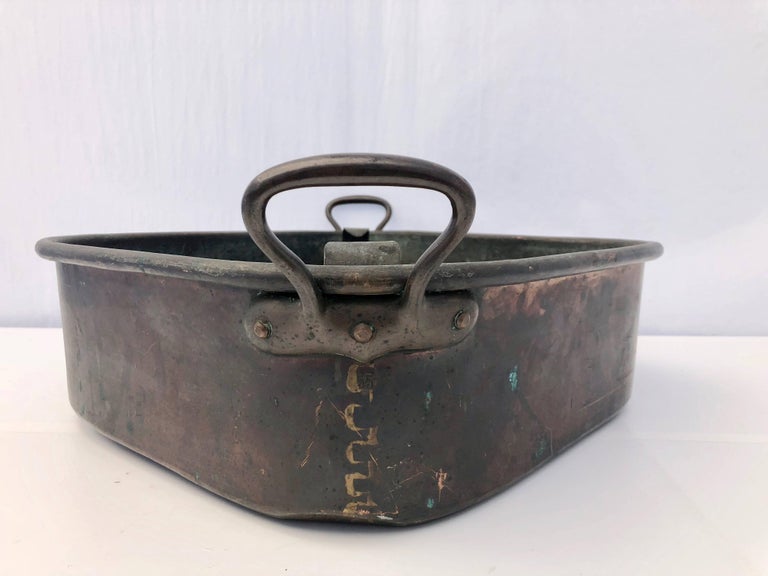 French 18th century copper turbot cooker pan (turbotière) with wrought iron handles and it's strainer.
The T-shaped soldering points are typical of the 18th century. The main reason why this copper pan has remained so popular for a few hundred
