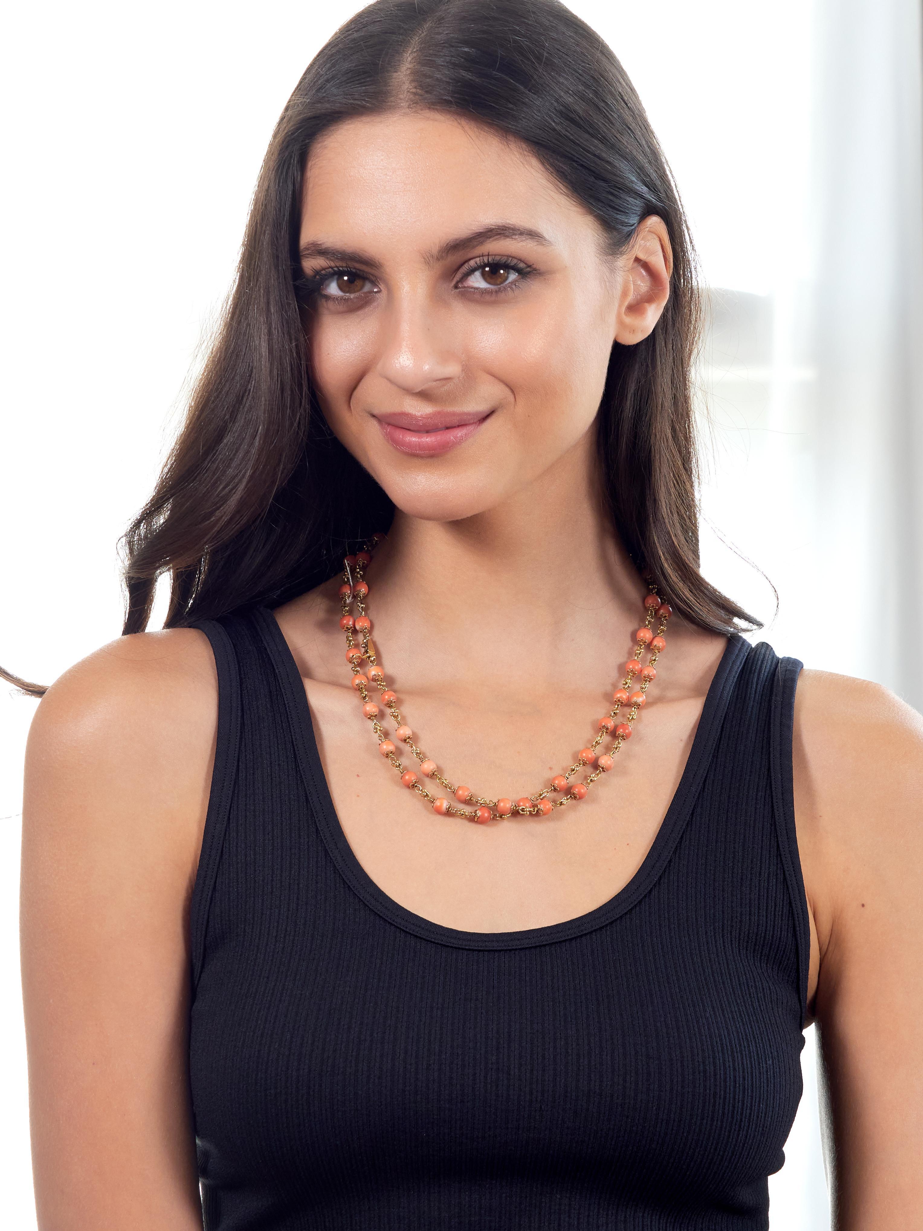 Comprised of gauge links alternating in pattern with 7.0 mm round coral beads
Opaque light to medium pinkish orange in color with white swirling
Accented by pierced floral motif terminals and strung on gold wire
Necklace can be extended via bracelet