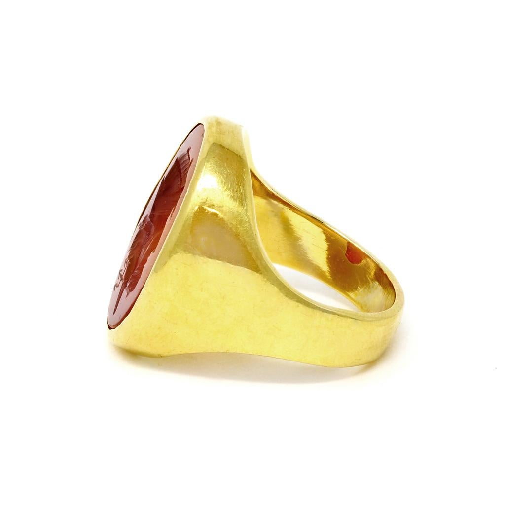 A French ring signed by the artist, Tatar featuring a Carnelian Intaglio with the face  of Triton son of Poseidon from the Greek mythology. This so called Chevalière ring set in 18k yellow gold was created by a well known artist Tatar from the