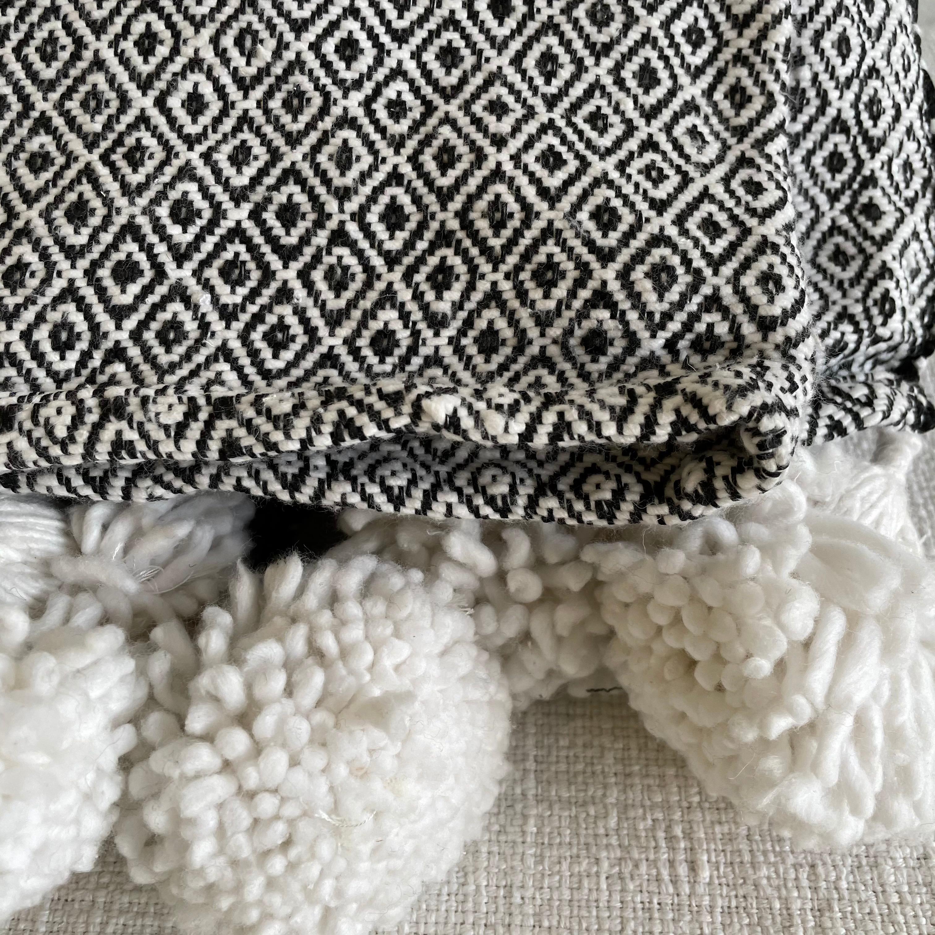 French cotton throw with tassels
Custom loomed in france for Bloom Home Inc.
This black and white diamond pattern throw has a heavy weight to it.
Measures: 72 x 108.