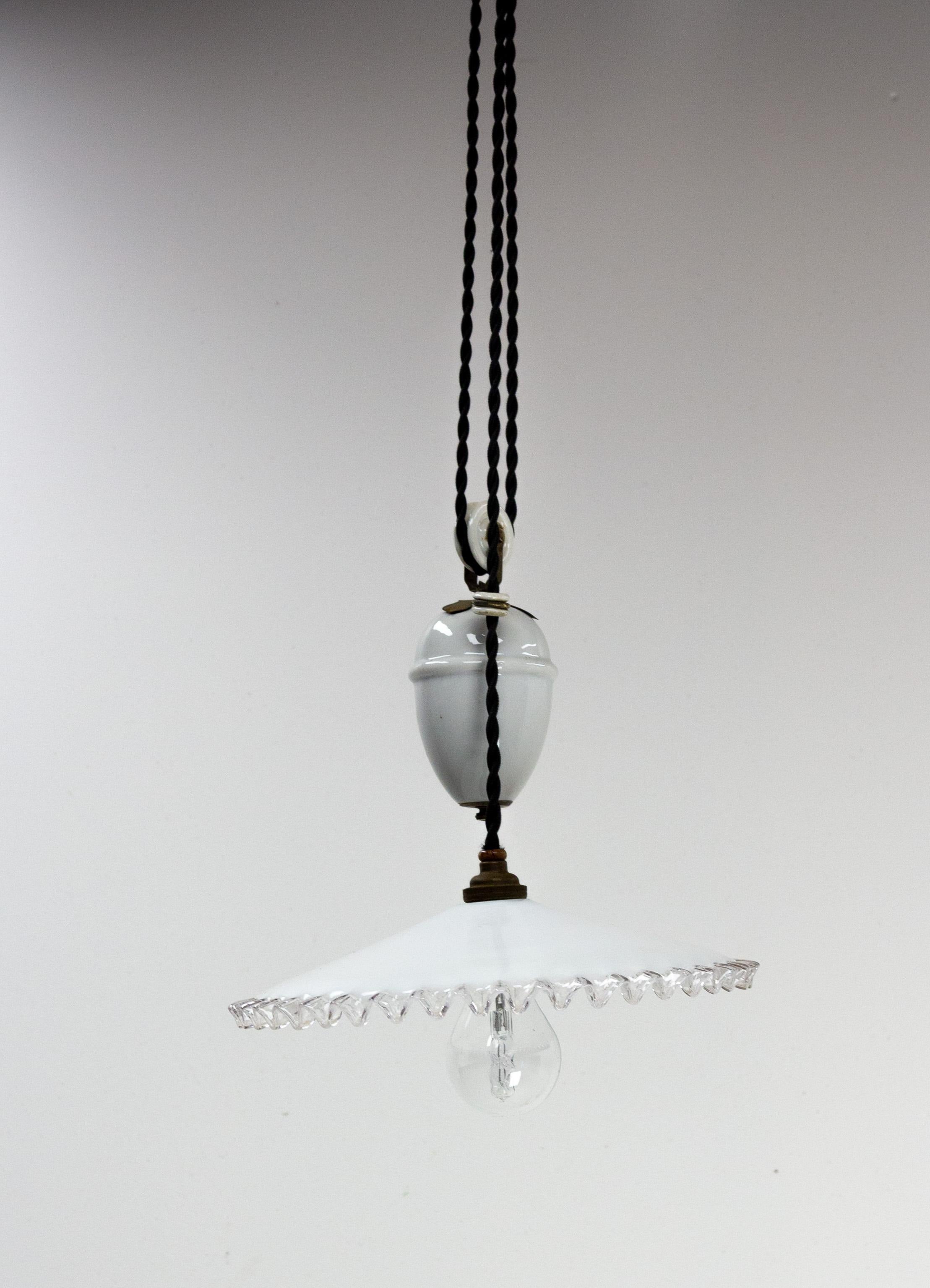 Ceiling pendant lamp in glass and opaline early 20th century.
French counter weight chandelier. White glass diffuser and porcelain weight for adjusting the overall length.
Height between 37 in. and 85.43 in. (94-217 cm)

Good antique condition 
This