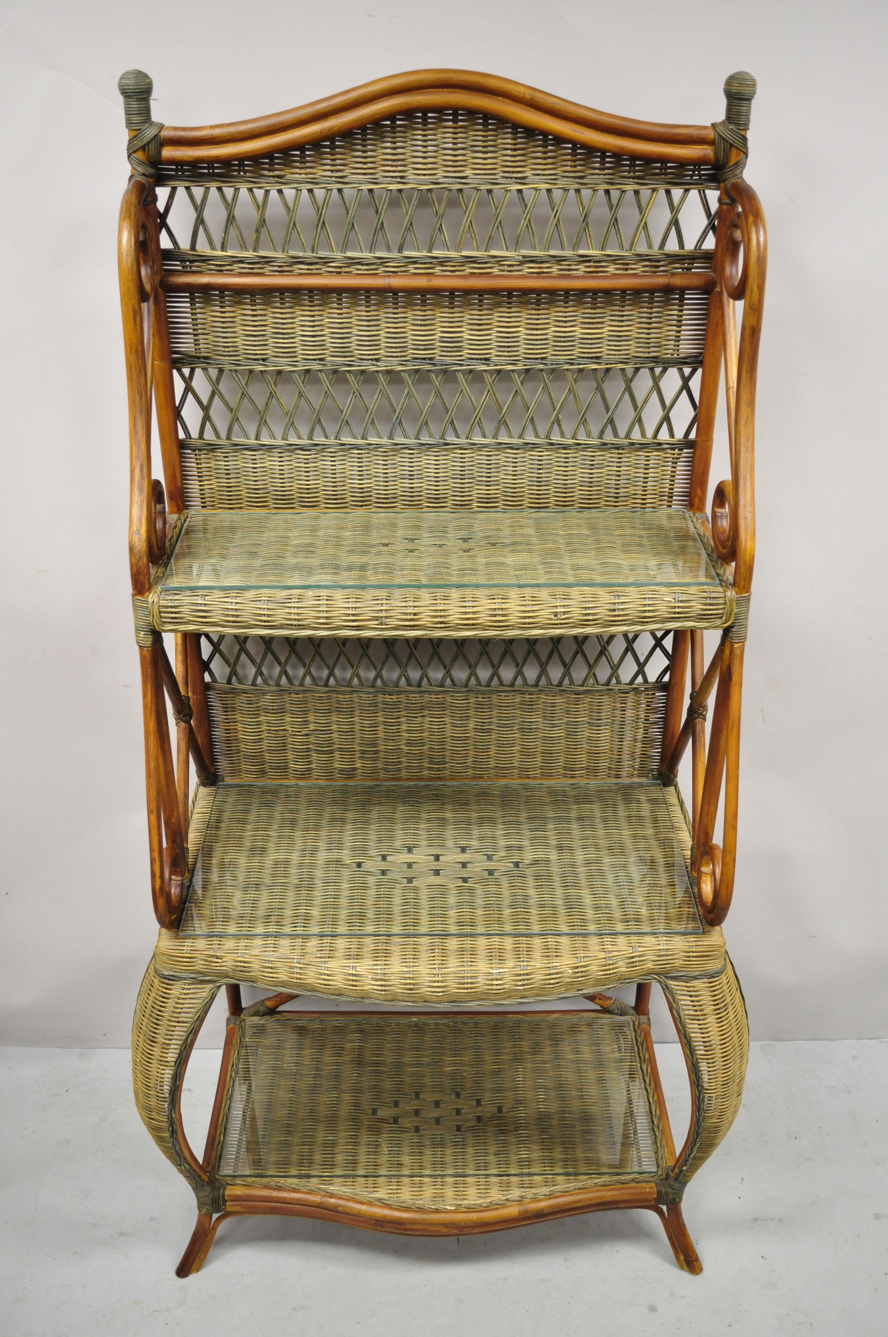 French Country style 3 tier wicker rattan wrapped frame kitchen bakers rack stand. Item features (3) glass shelves, synthetic wicker wrapped frame, (3) tiers, shapely design, great style and form. Circa 20-21st Century, Pre-owned. Measurements:
