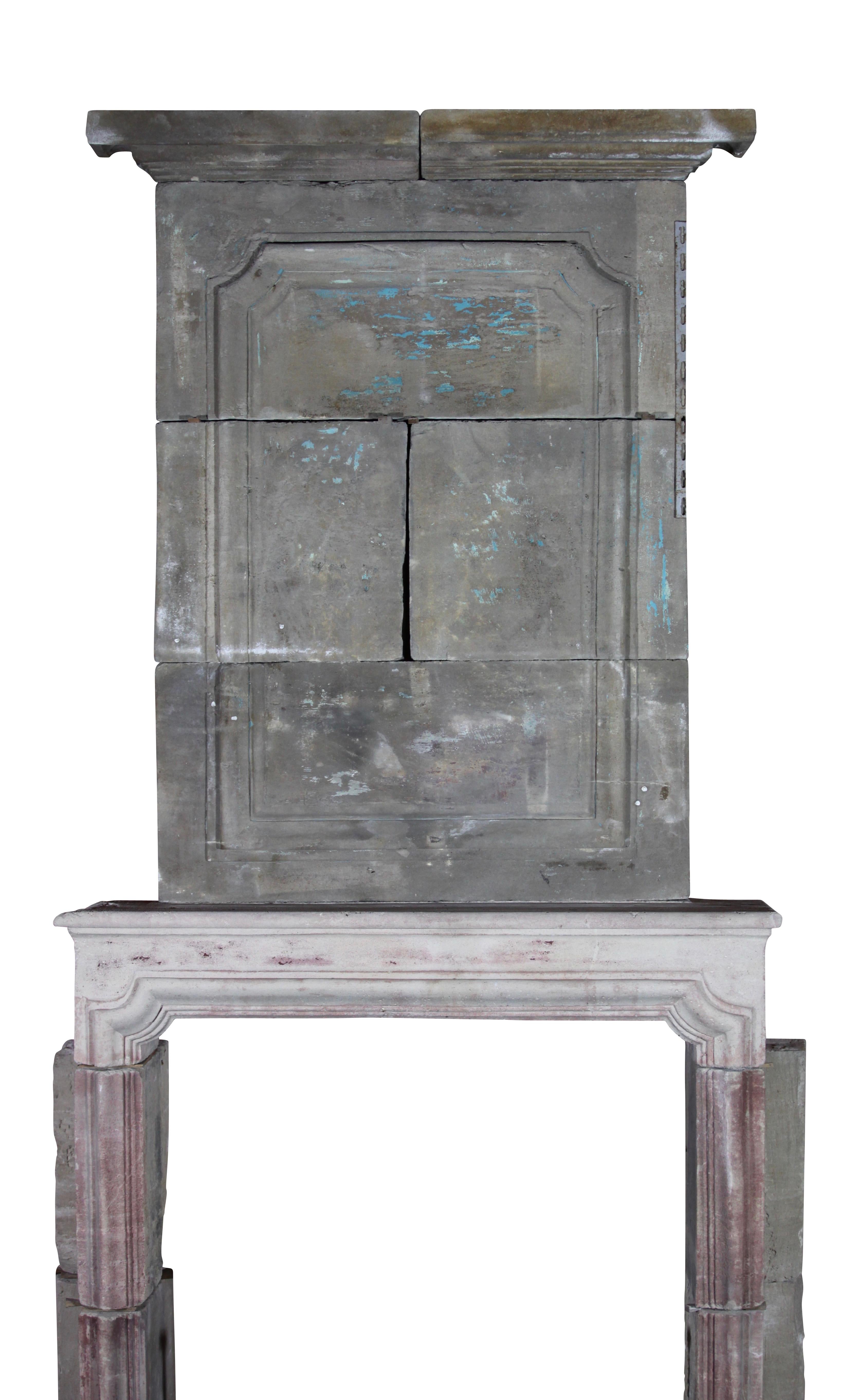 This rustic original antique fireplace surround in Grez limestone has small proportions. While the front piece looks clearer due to the original patina in real the difference is less. A perfect fireplace piece to chalk, the old fashion way.