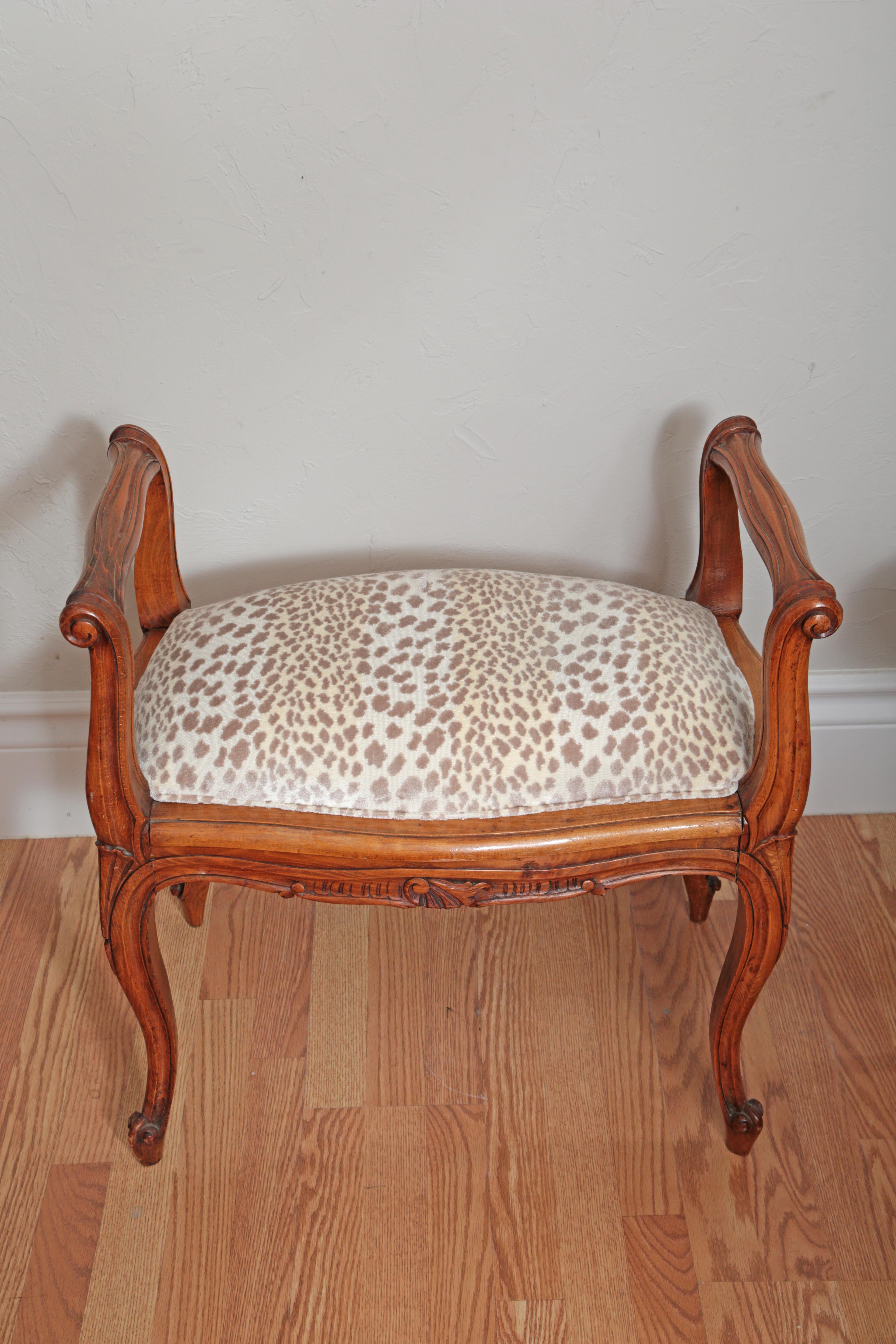 Country French bench with newly upholstered animal print cut velvet seat cushion.