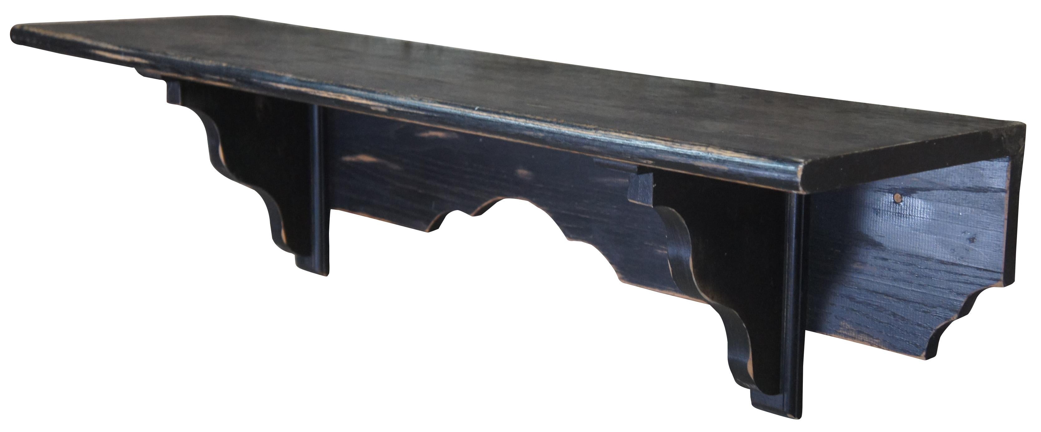 Late 20th century black washed oak wall shelf. French country or farmhous style. Great for storage or display. Hooks can be added to make it a hall tree. Measure: 48
