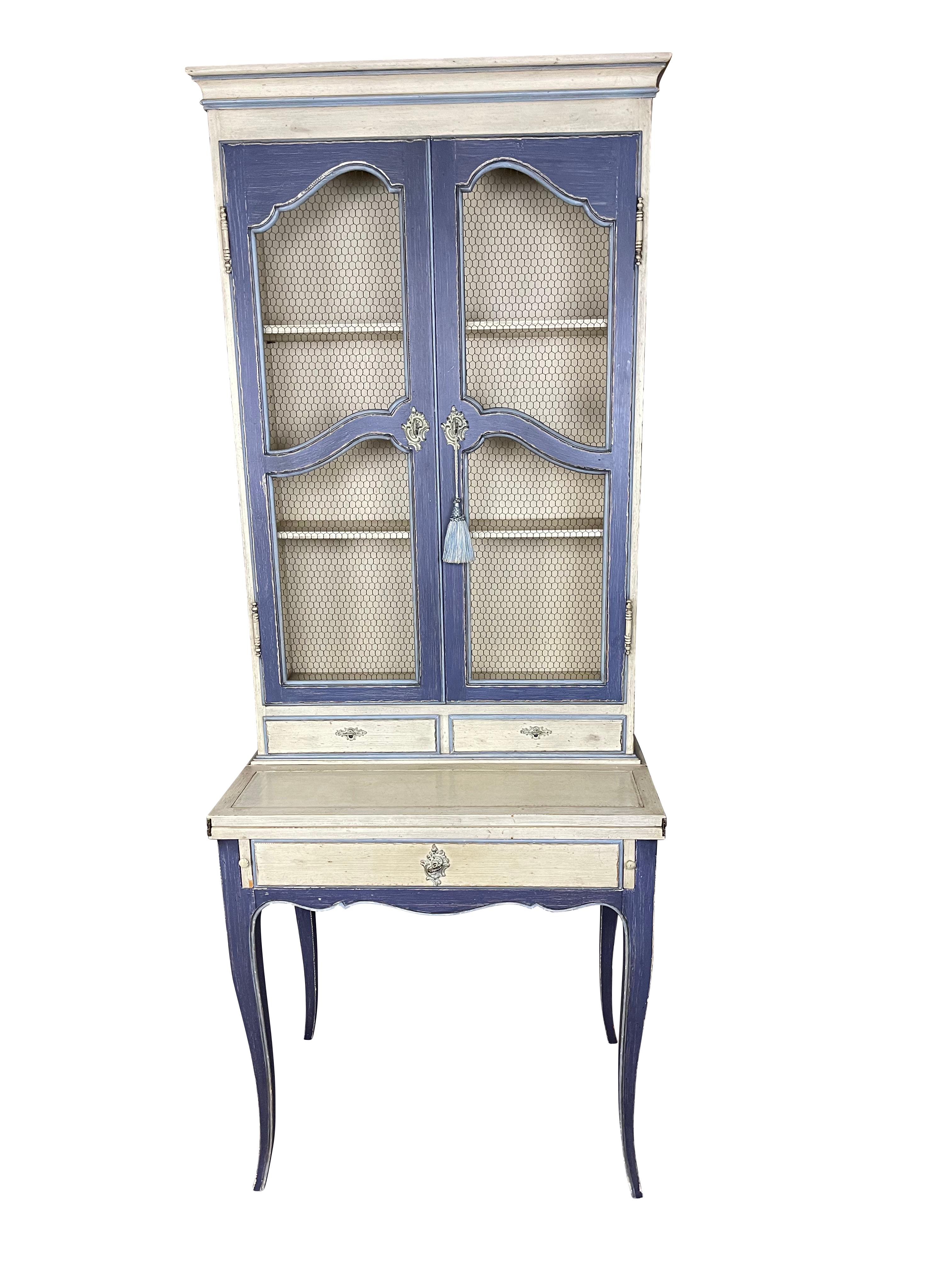 French country/ provincial hand-painted desk with wire fronted book shelves, drawer, and pull-out desk which opens to 18 inches.  The desk is painted in a lovely French blue and cream paint with an original key on a tassel. Arched wire doors are