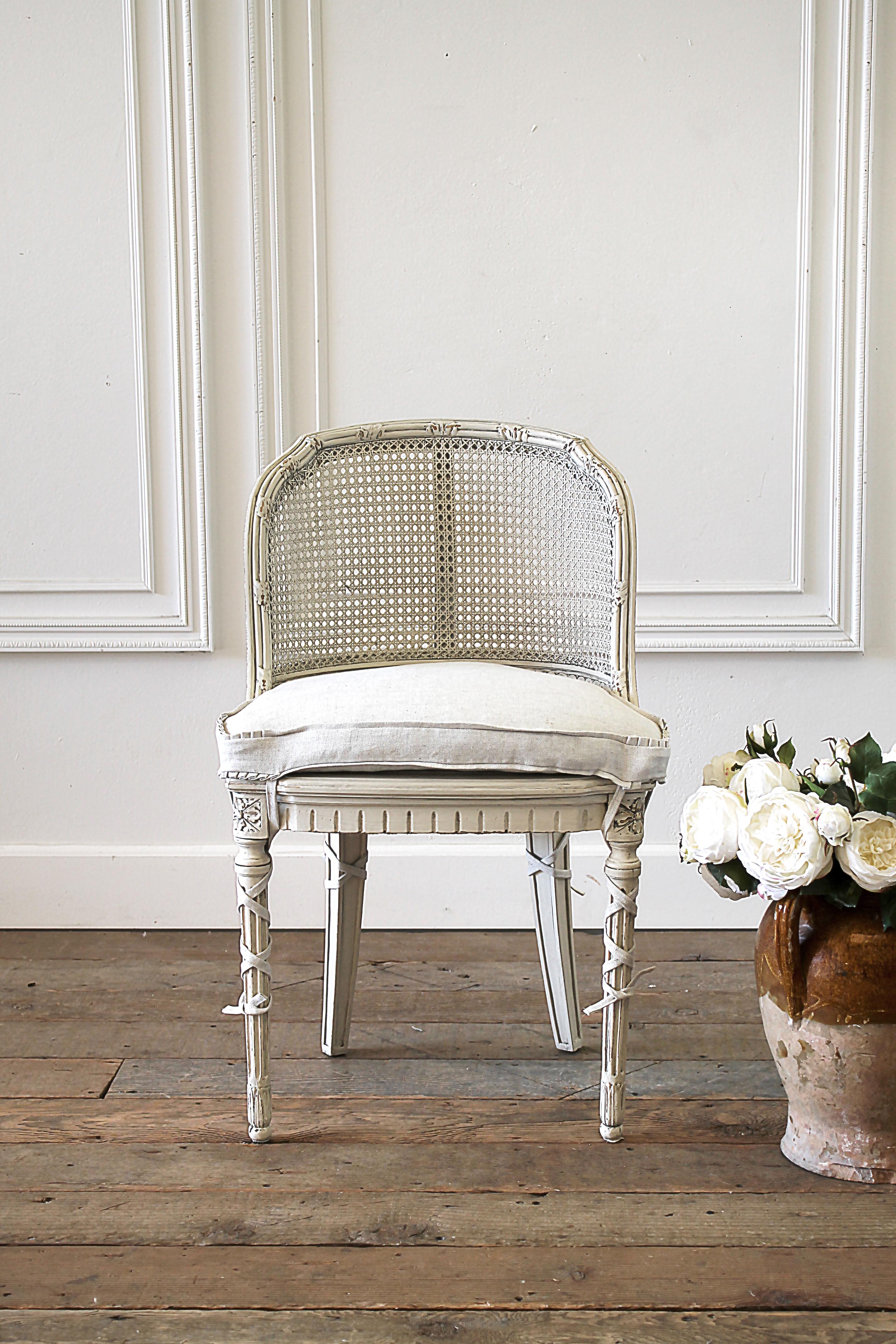 French Country cane back vanity chair
Painted and upholstered Louis XVI style vanity chair in natural linen. Painted in our soft oyster white, with subtle distressed edges, and finished with an antique glazed patina. This off white color blends