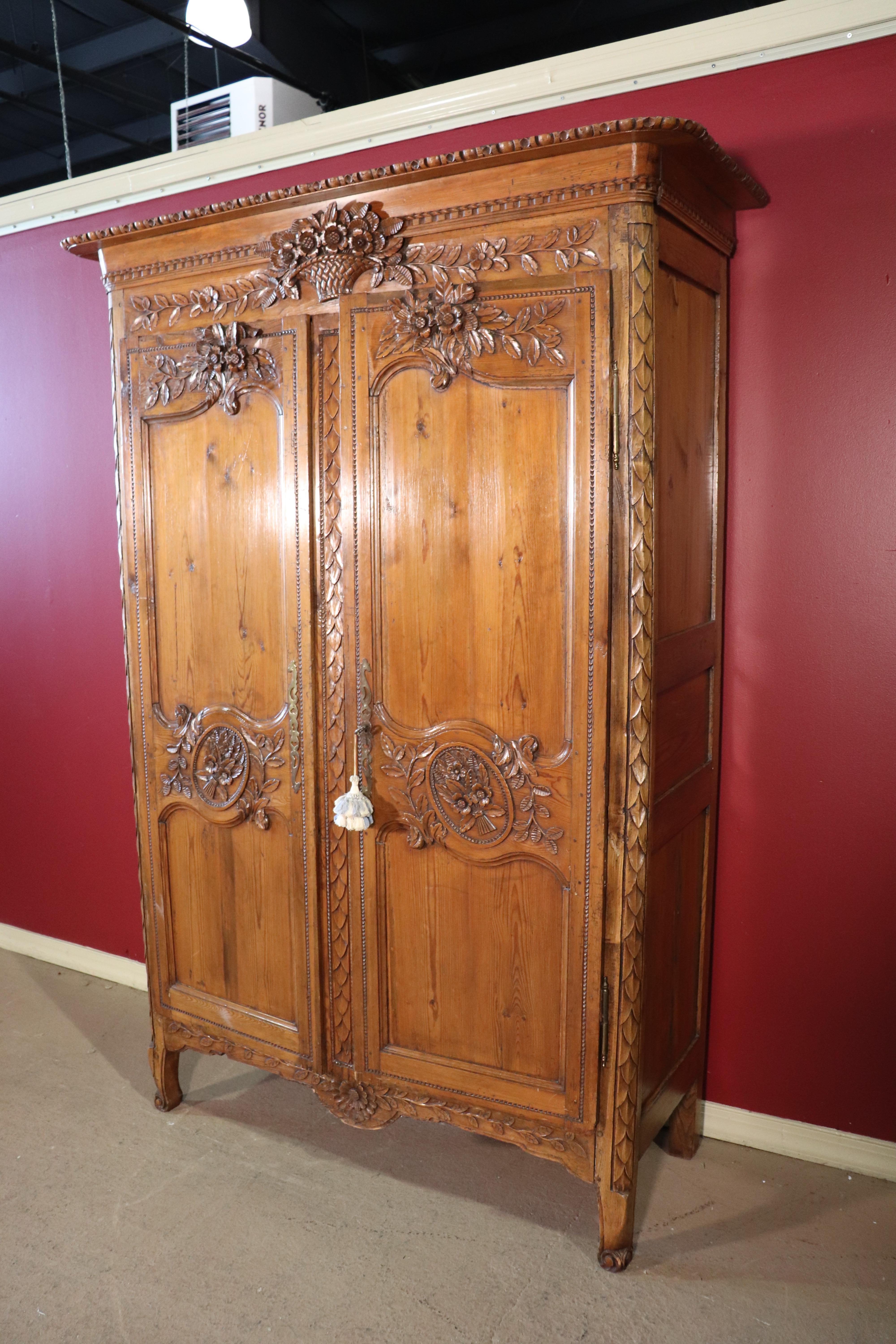 This is a beautifully carved pine French country armoire, circa 1840. The armoire has been converted to use for a television but that was commonly done in the early 2000s as many already know. The armoire features fine carving and great antique
