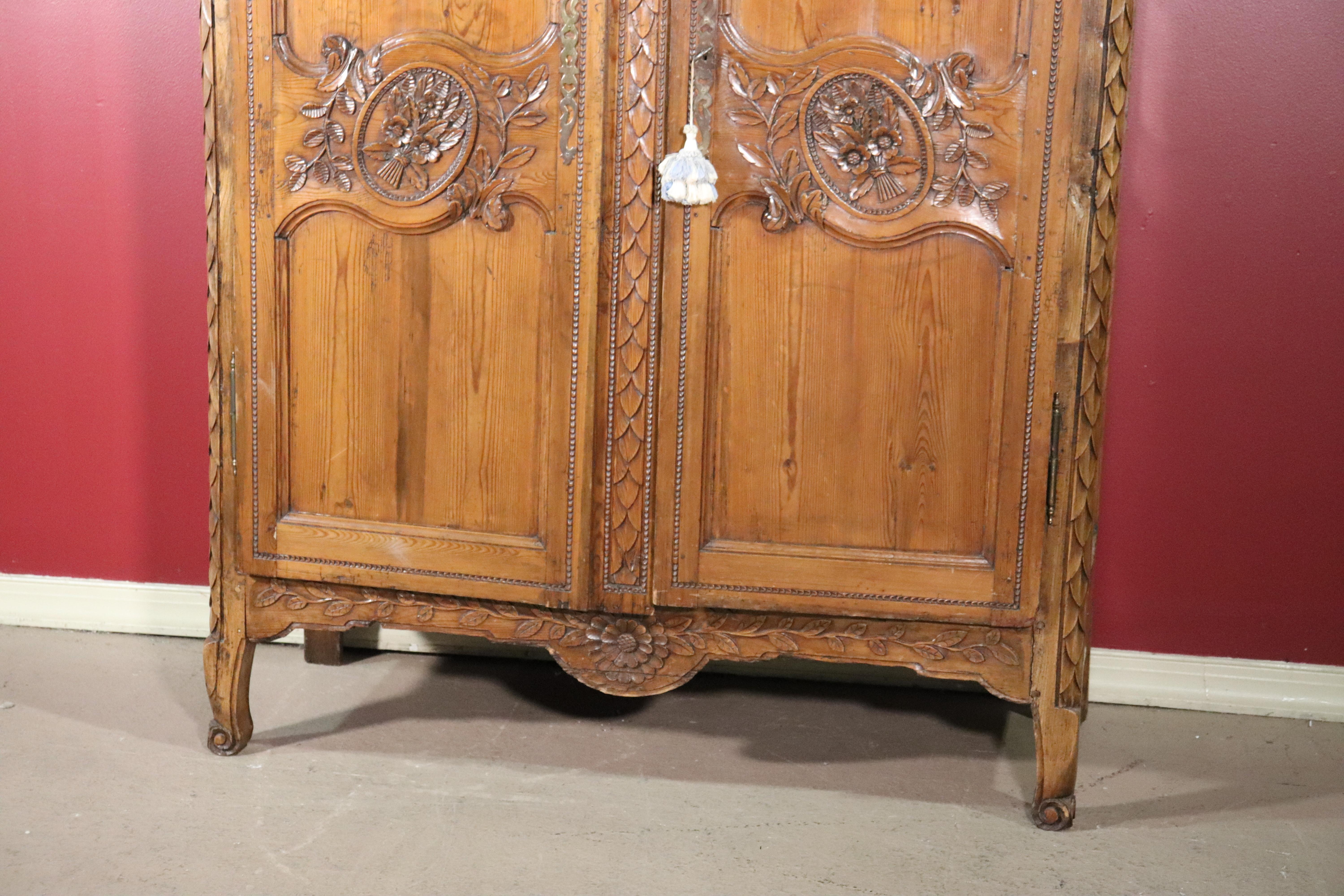 Mid-19th Century French Country Carved Pine Wedding Armoire Wardrobe with Basket of Flowers