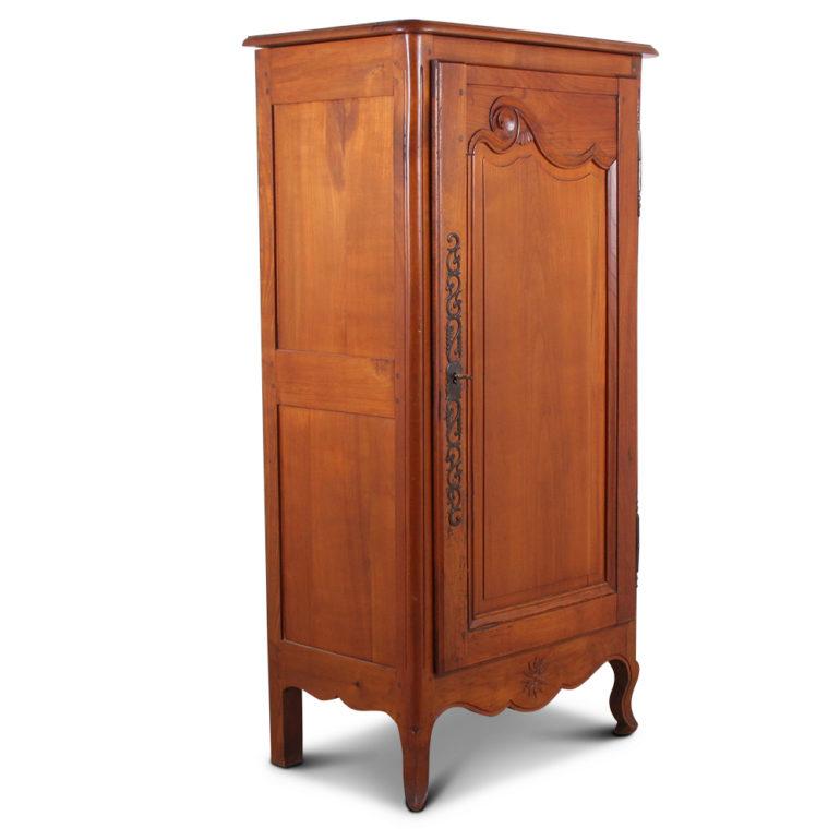 A French, solid cherry, single-door cabinet with a carved and shaped frame-and-panel door and carved detailing to the lower apron. Fitted with two interior shelves. Circa 1920.



  