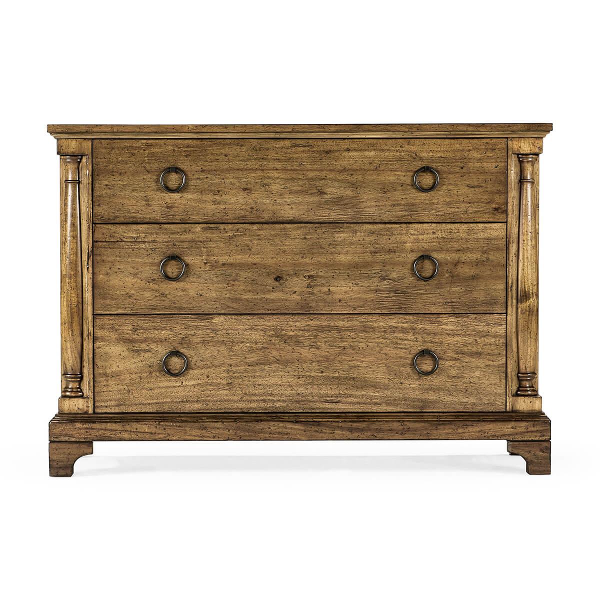French Country rustic chest of drawers in our medium driftwood finish with three drawers, column form styles, with a stepped pedestal base on bracket feet and brass ring handles.

Dimensions: 47.25